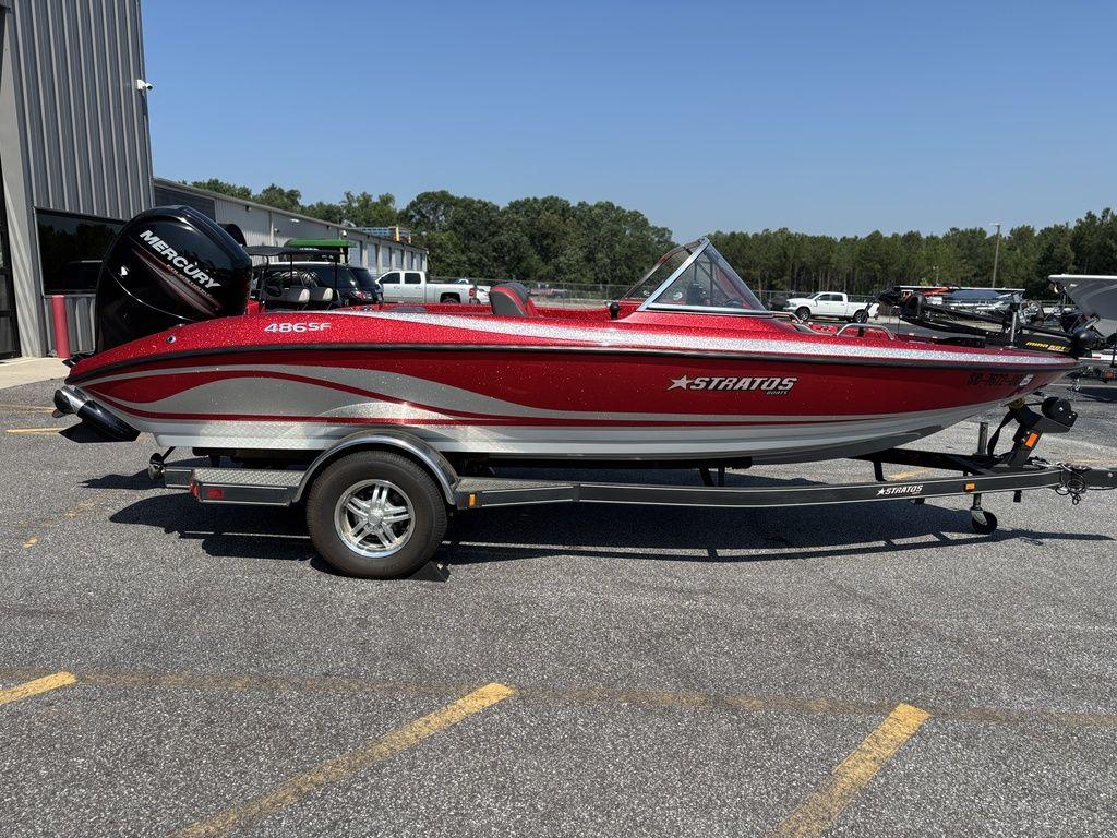 Red 2013 Stratos 486 SF boat on trailer, parked outdoors, featuring Mercury engine.