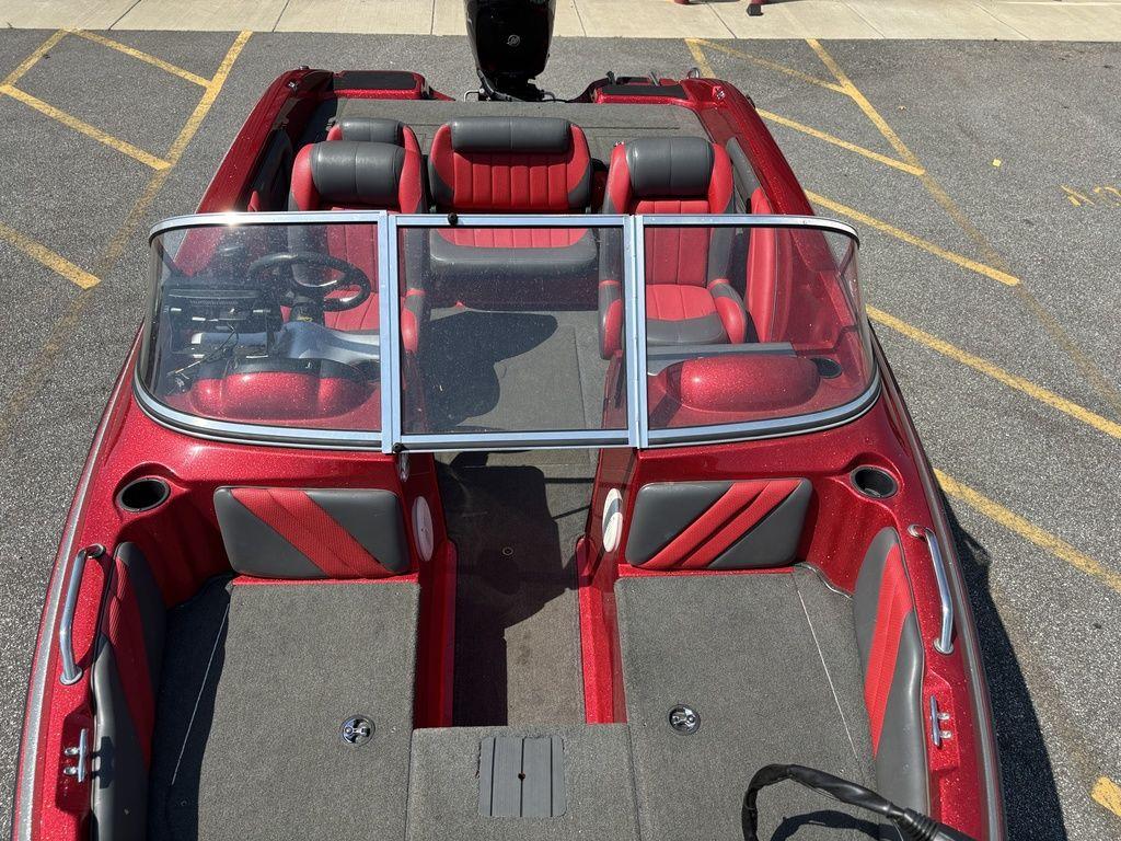 Red and gray 2013 Stratos 486 SF boat interior with seating and steering wheel.