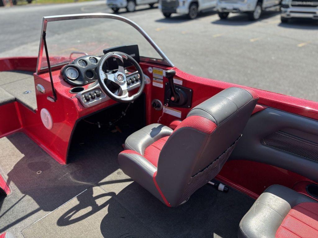 Red Stratos 486 SF boat interior with steering wheel and seats, 2013 model.