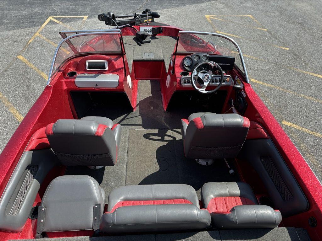 Red 2013 Stratos 486 SF boat interior with steering wheel and seating arrangement.