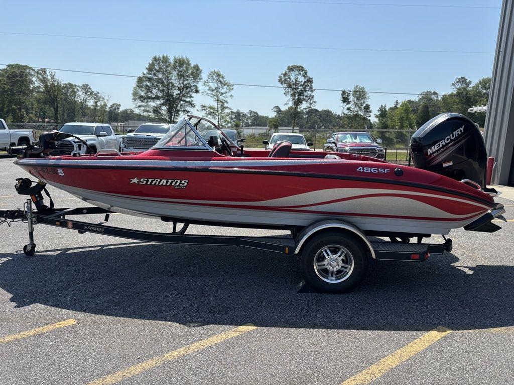 Red 2013 Stratos 486 SF boat on trailer, parked outdoors.