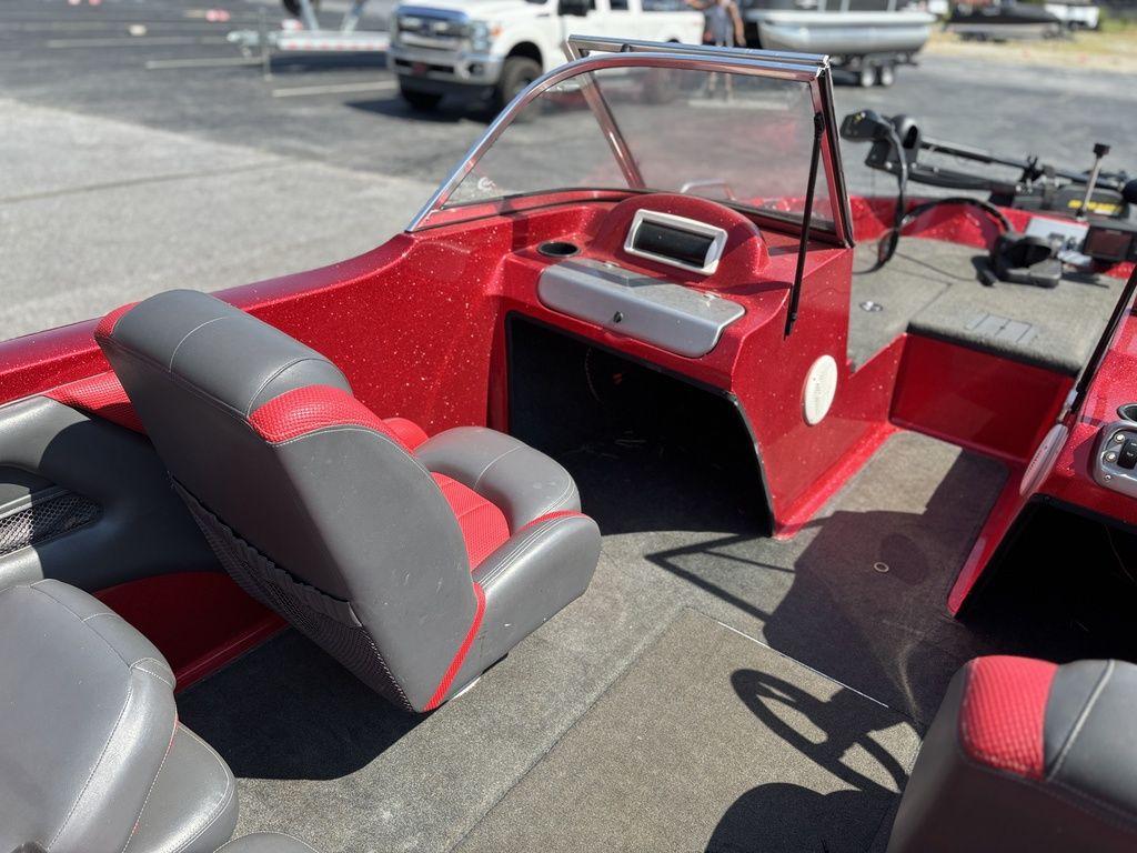 Interior of a 2013 Stratos 486 SF boat with red and gray seating.