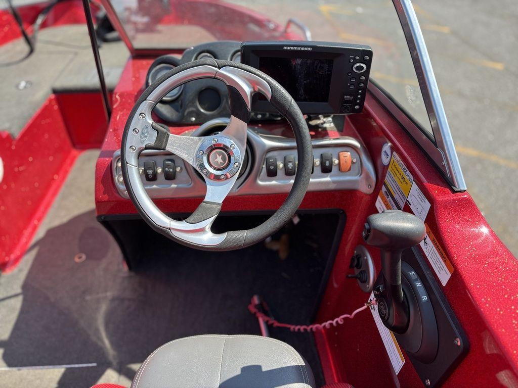 Red Stratos 486 SF boat dashboard with steering wheel and control panel, 2013 model.