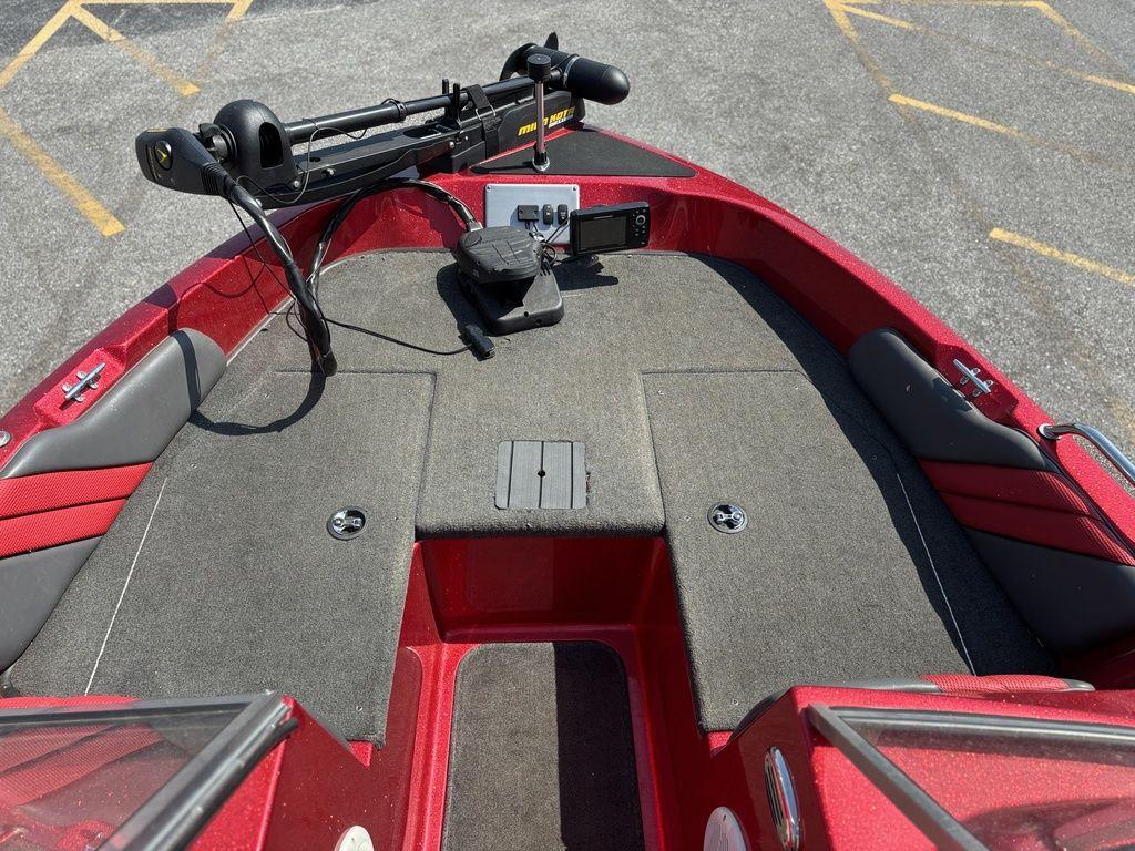 Red 2013 Stratos 486 SF boat deck with trolling motor and carpeted surface.
