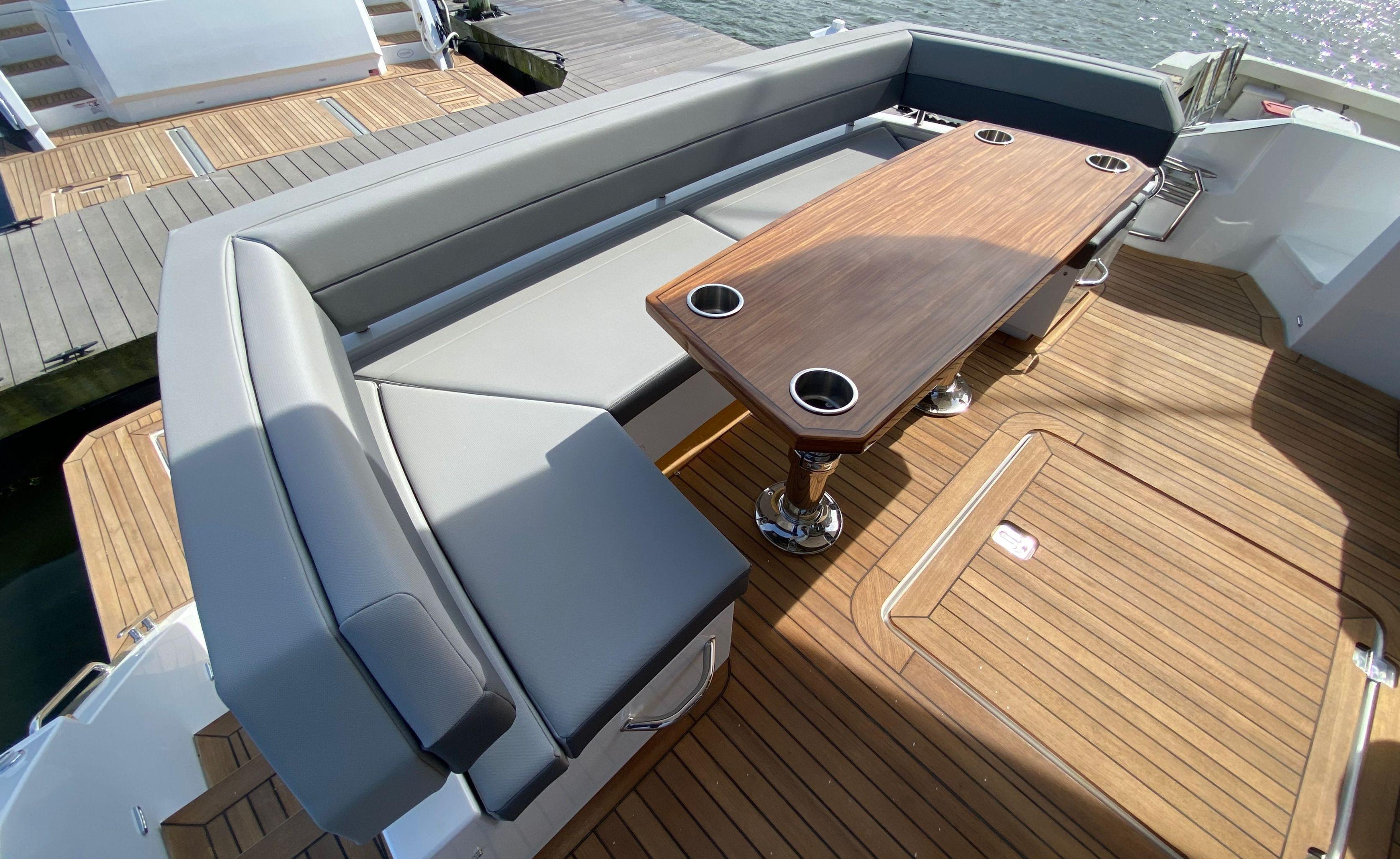 Cruisers Yachts-60 Fly 2022-RADIANT NY-US-Luxurious seating area on 2022 Cruisers Yachts 60 Fly with wooden table and cup holders.-9652120 | Thumbnail