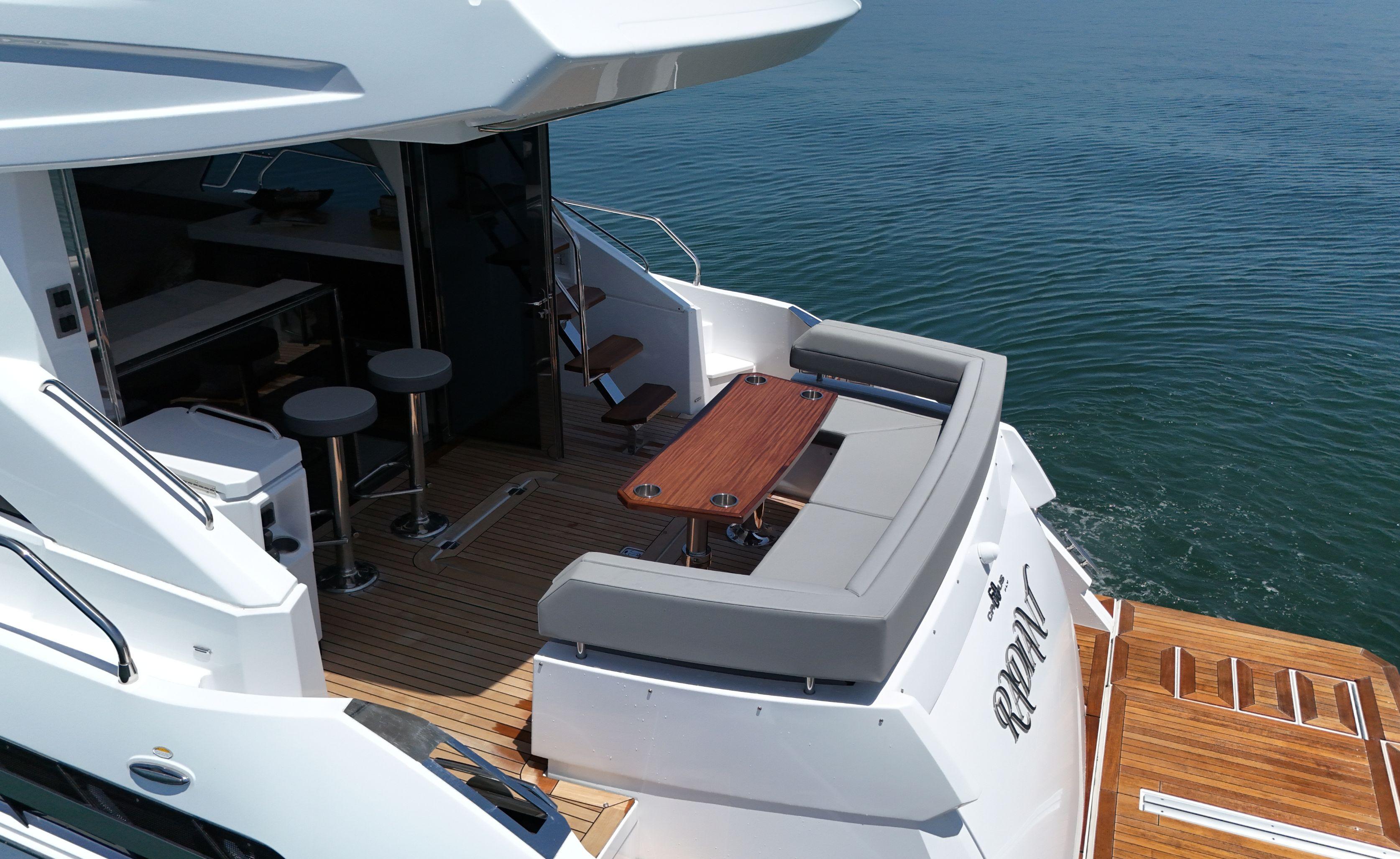 Cruisers Yachts-60 Fly 2022-RADIANT NY-US-2022 Cruisers Yachts 60 Fly, luxurious deck with seating and table, overlooking serene water.-9652120 | Thumbnail