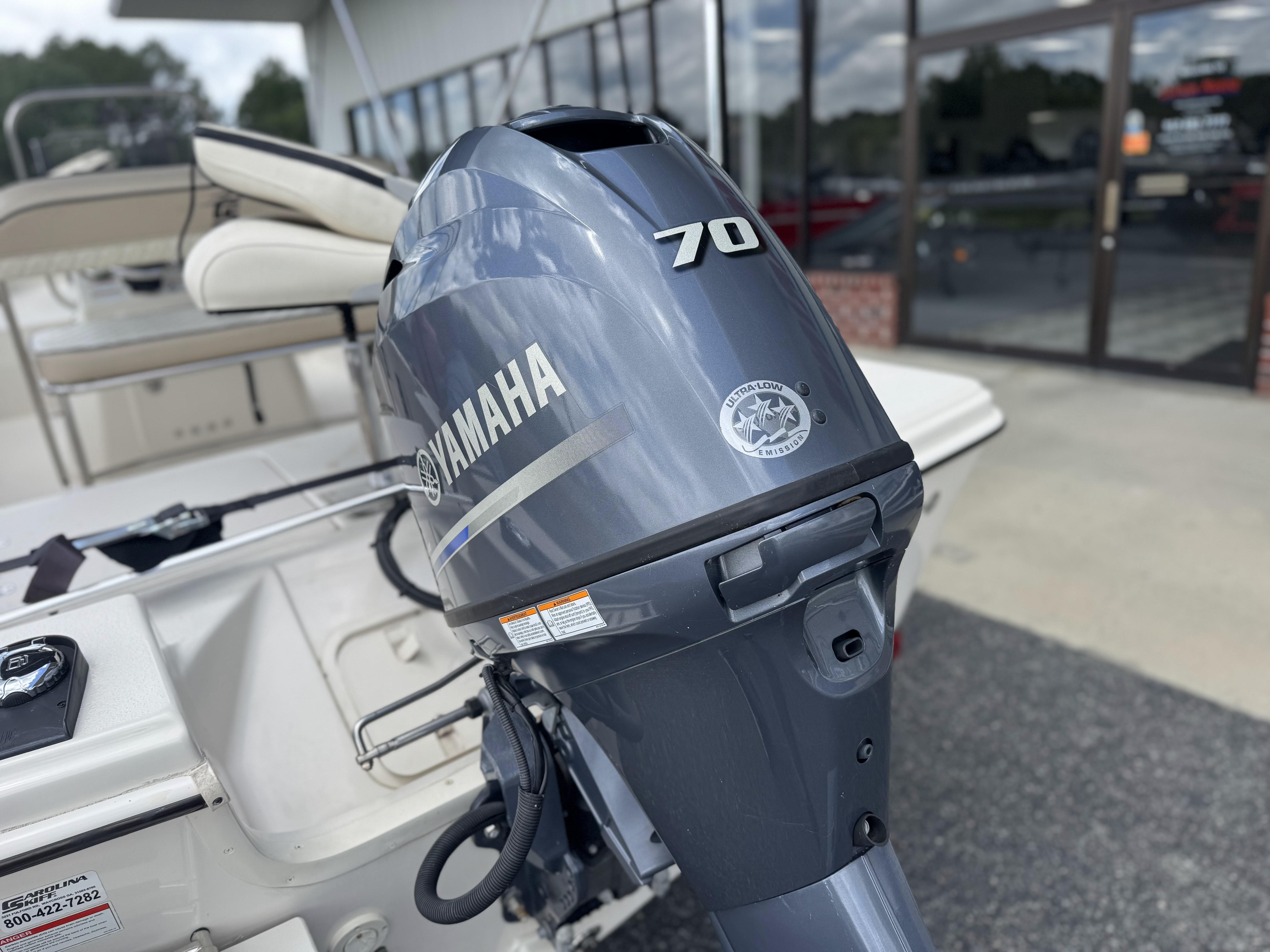 2020 Carolina Skiff 178JLS with Yamaha 70 outboard motor, parked outside dealership.