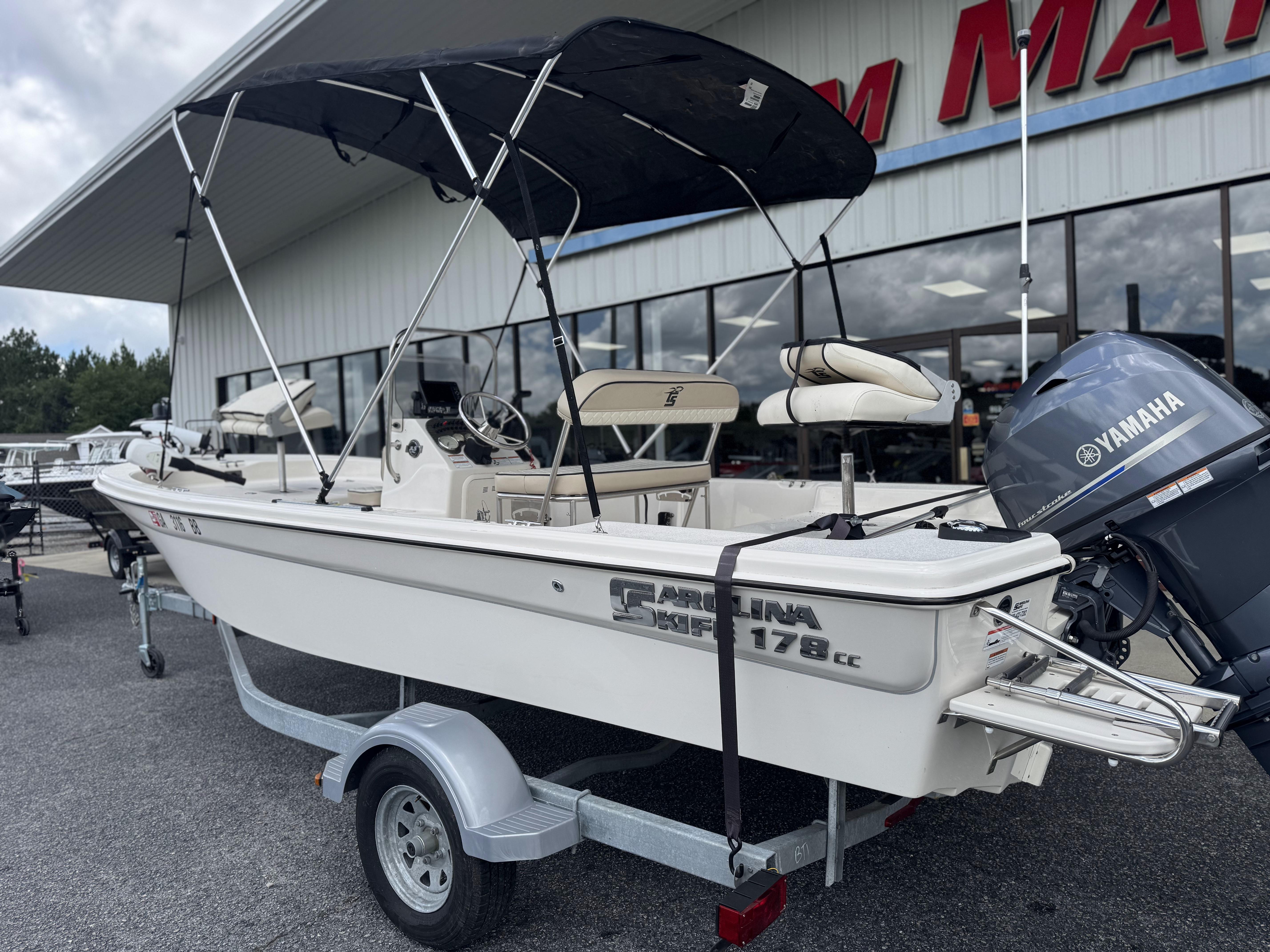 2020 Carolina Skiff 178JLS boat with Yamaha motor on trailer, parked outside dealership.