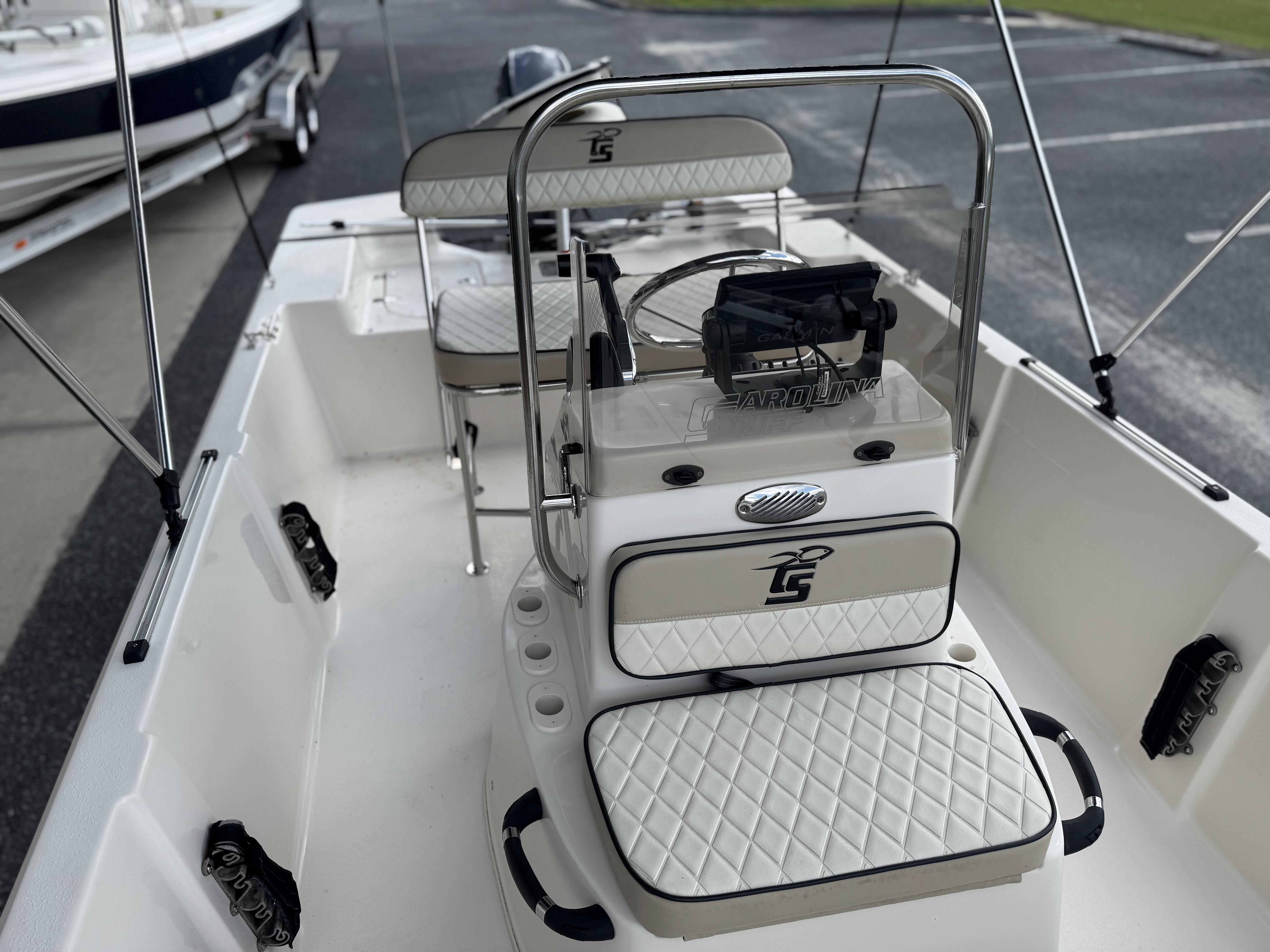 2020 Carolina Skiff 178JLS boat interior with white seating and steering console.