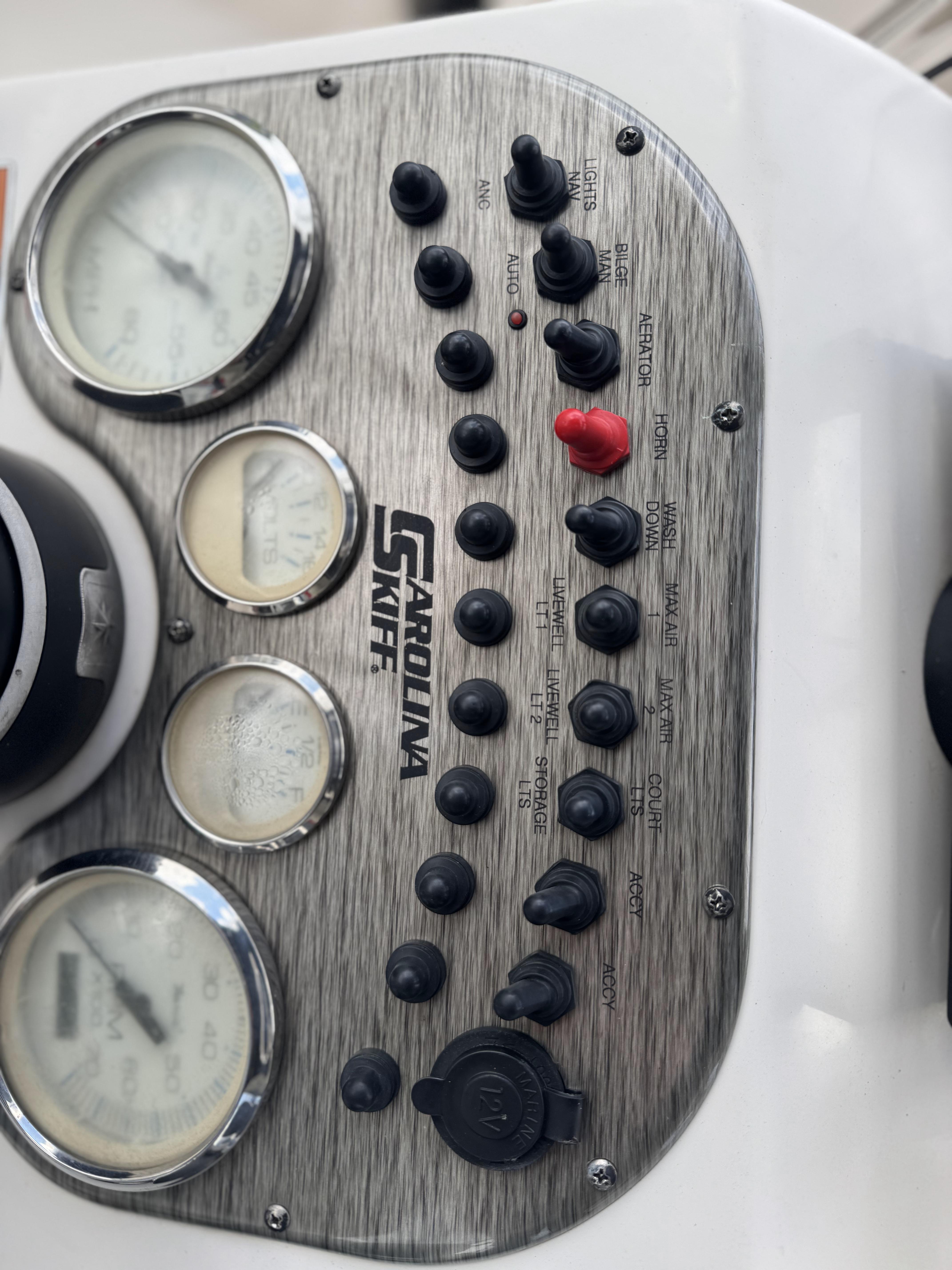 Control panel of a 2020 Carolina Skiff 178JLS boat with gauges and switches.