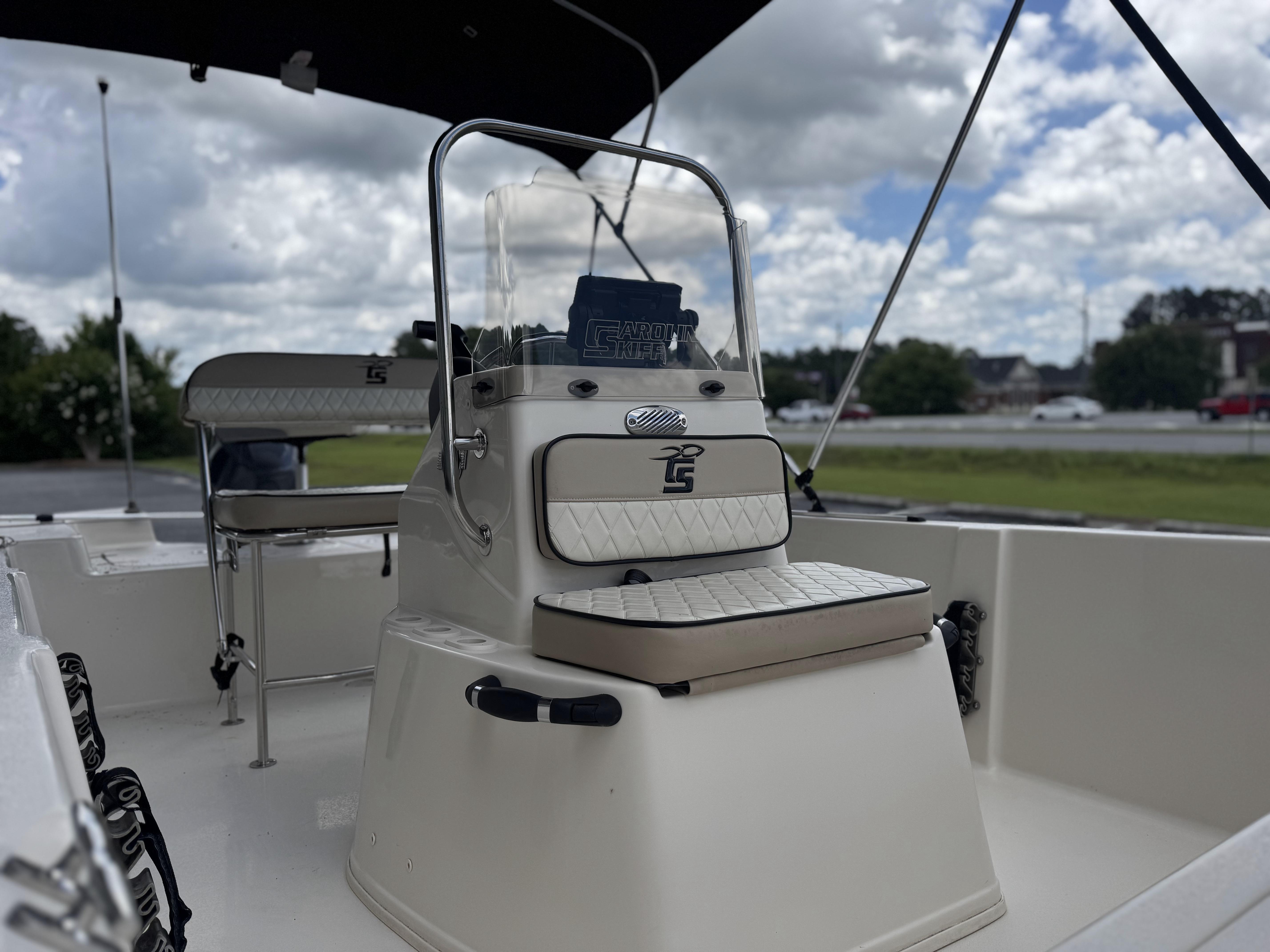 2020 Carolina Skiff 178JLS boat interior with seating and console under cloudy sky.