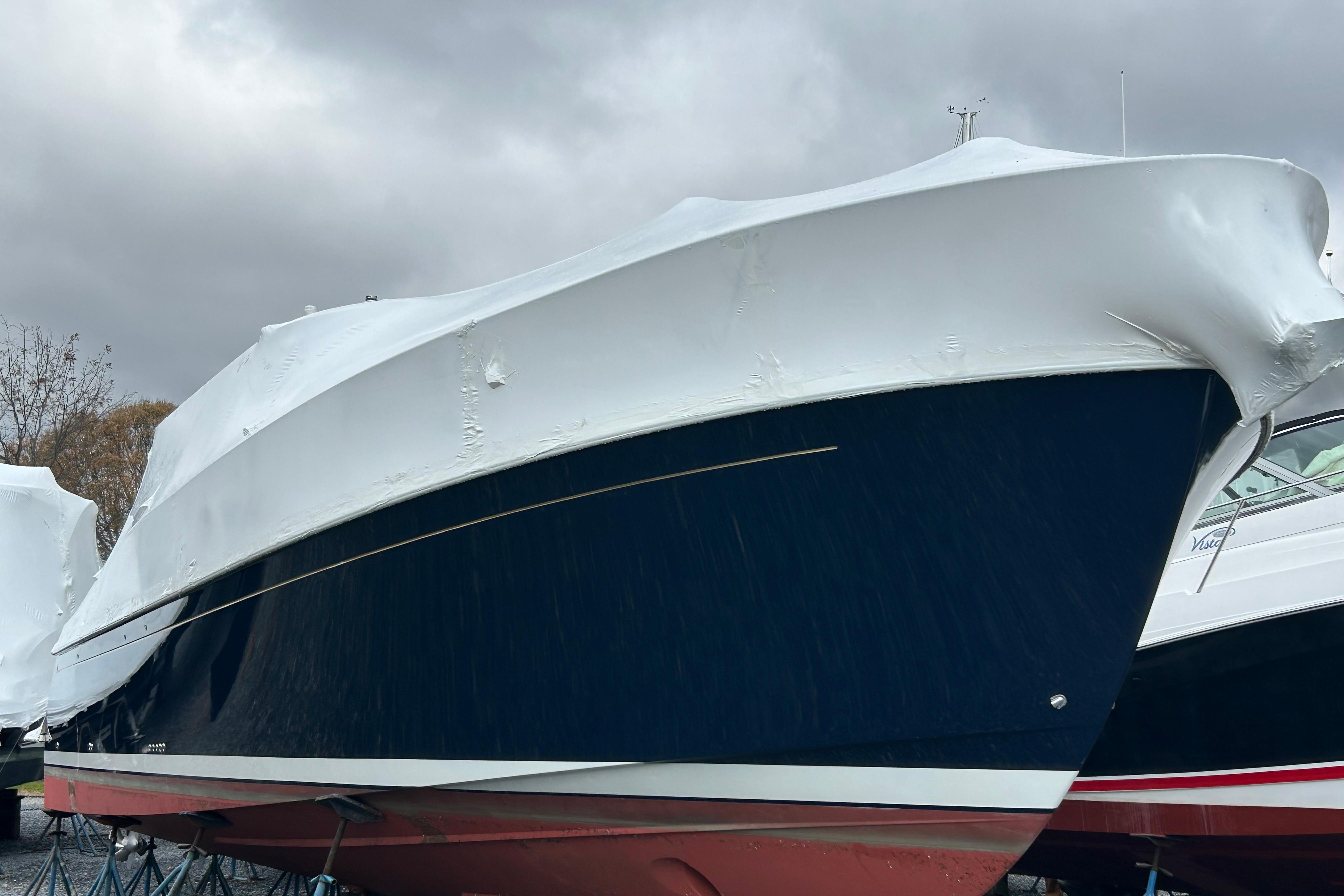 2023 Back Cove 39O boat covered in protective wrap, easily boarded with zipper door.