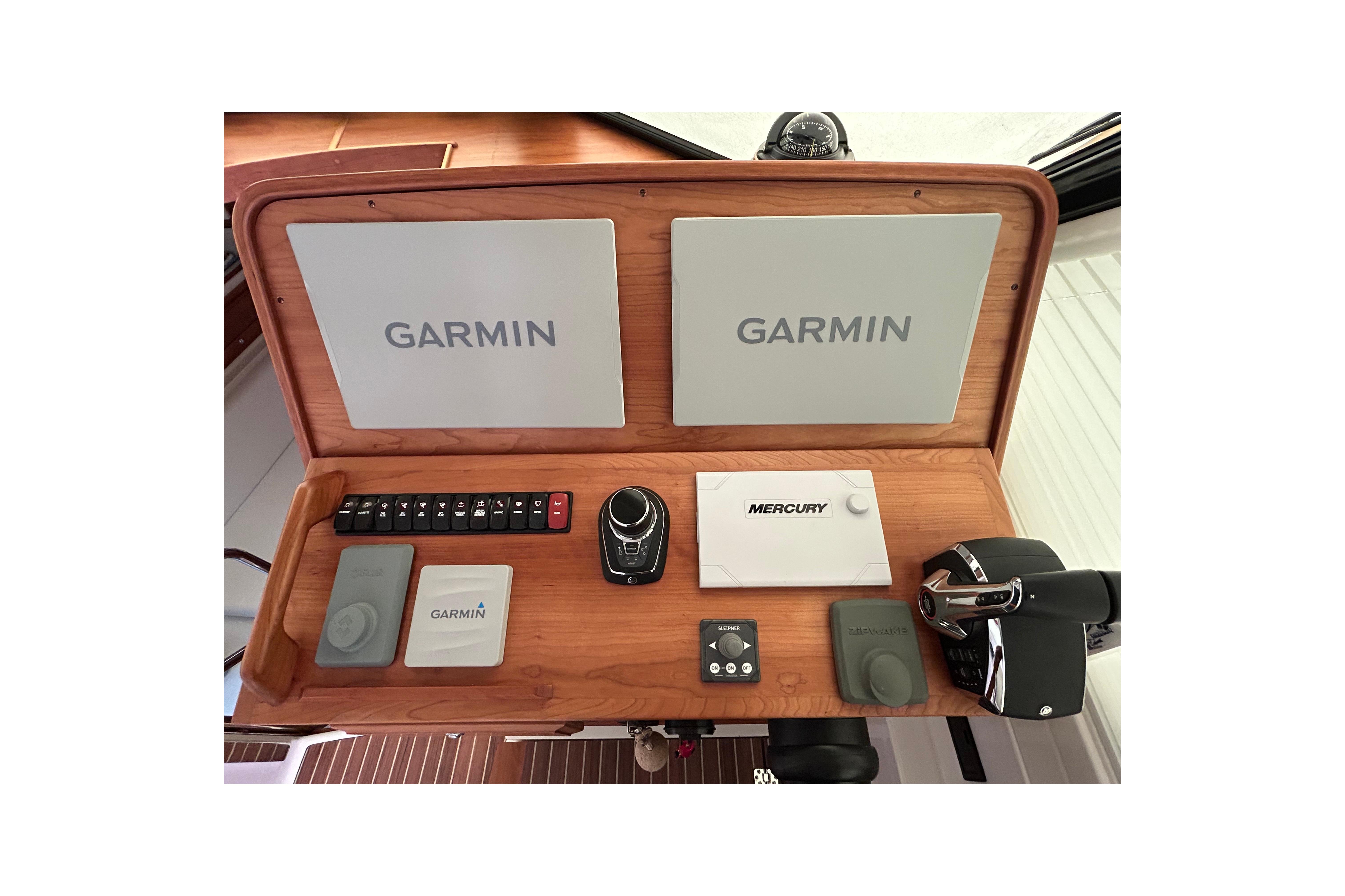 2023 Back Cove 39O helm with Garmin and Mercury controls, featuring dual screens, Flir night vision, bow thruster and joystick.