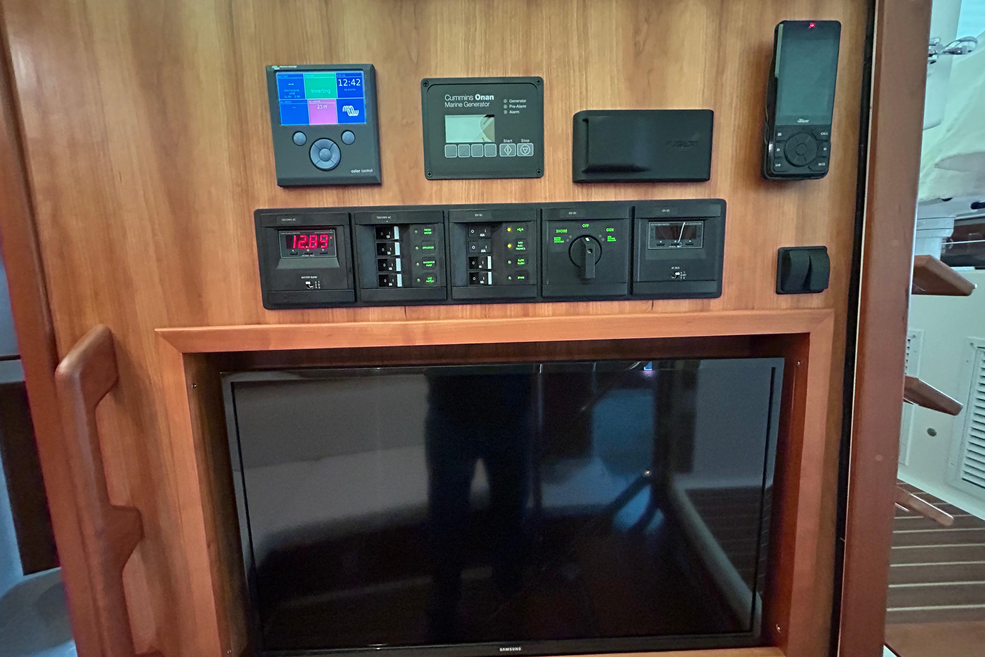 Distribution panel, mid cabin TV, VHF with AIS, and invertor/charger