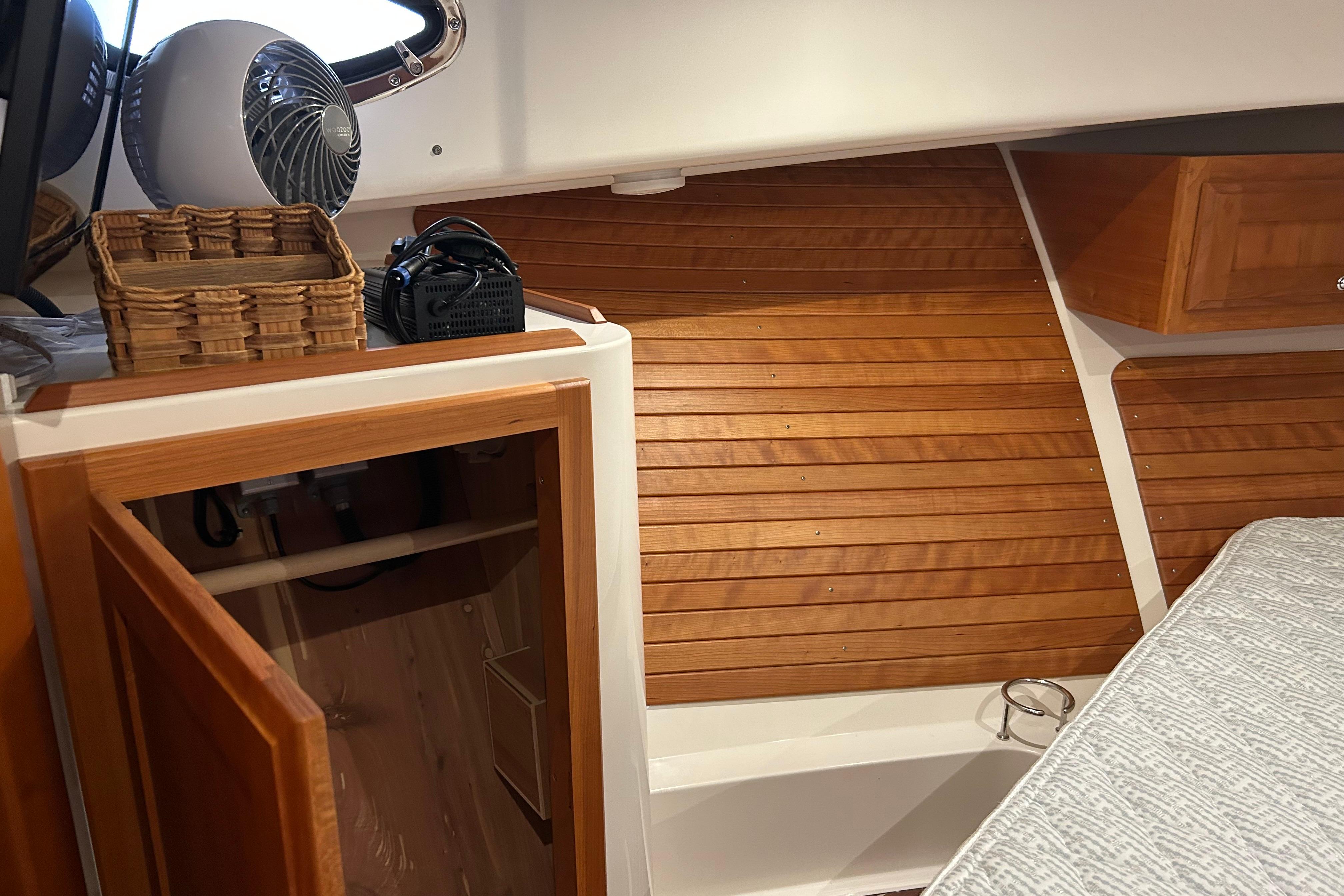 2023 Back Cove 39O cabin interior with wooden paneling and open storage.