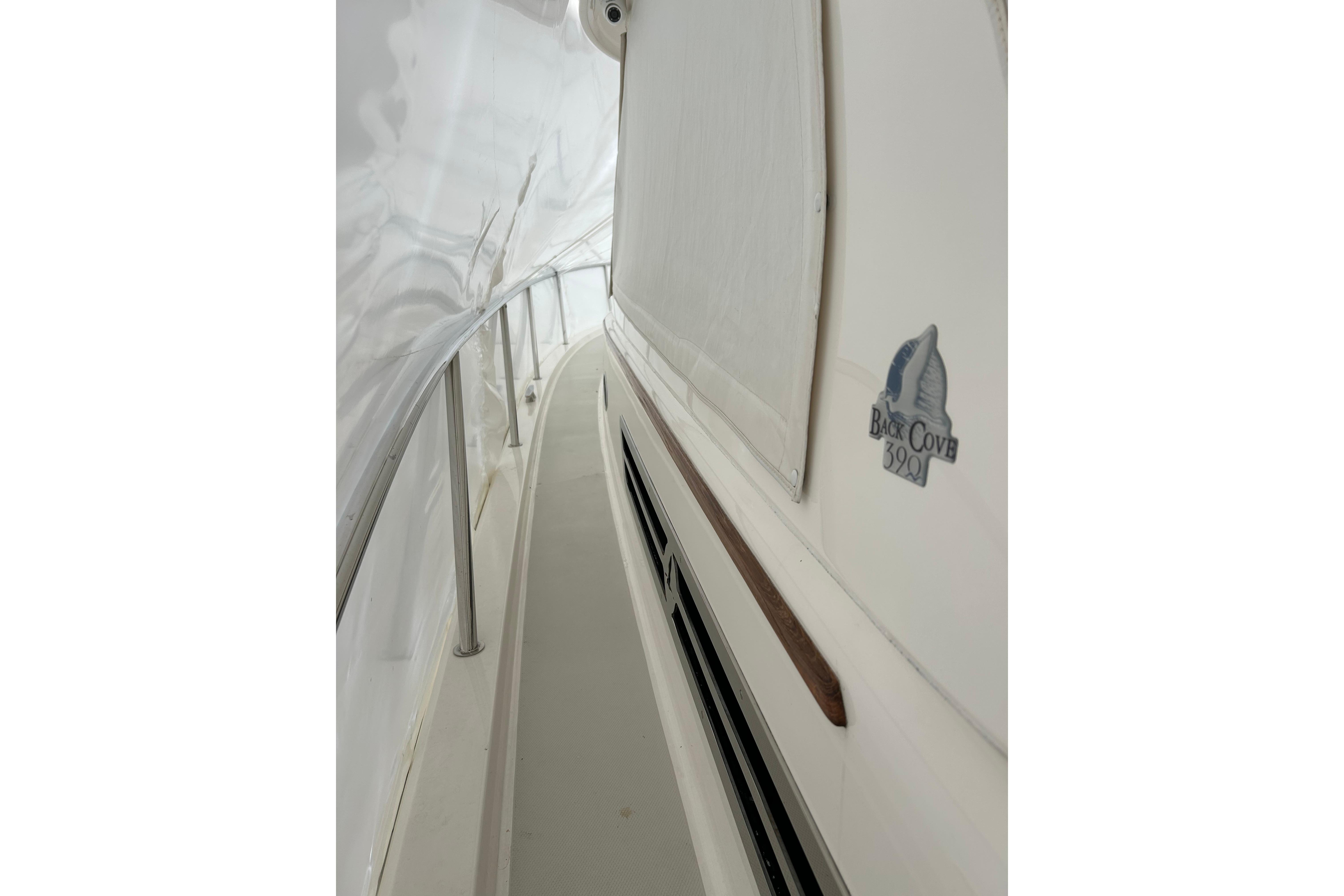 Side view of 2023 Back Cove 39O yacht, showcasing sleek design and logo.