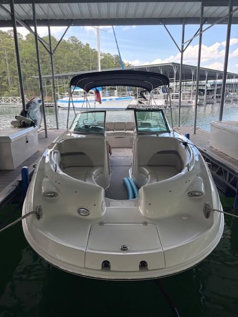 2007 Chaparral Sunesta 274 boat docked under a covered marina.