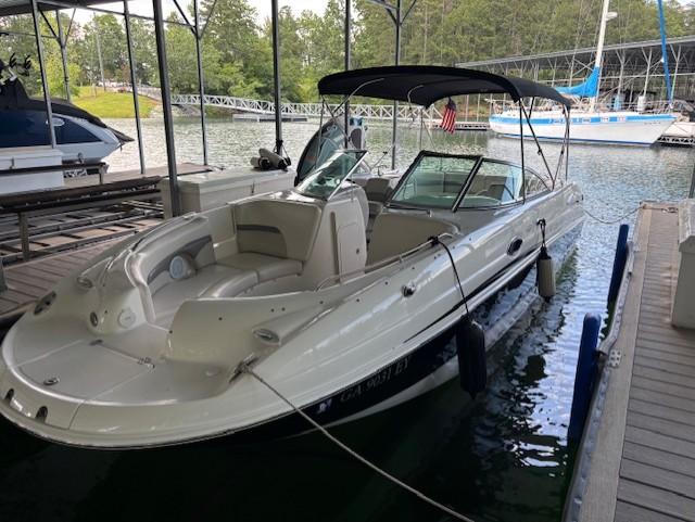 2007 Chaparral Sunesta 274 boat docked in a marina with canopy and seating.