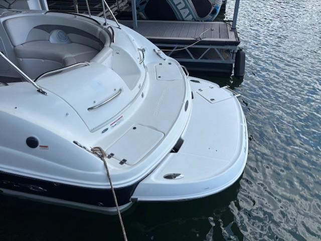 2007 Chaparral Sunesta 274 boat docked, featuring spacious seating and swim platform.