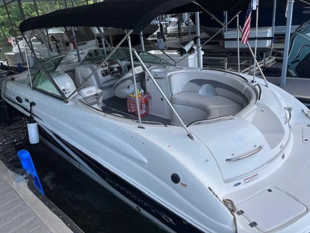 2007 Chaparral Sunesta 274 boat with canopy docked in marina.