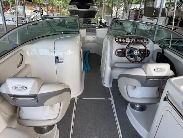 2007 Chaparral Sunesta 274 boat interior with seating and dashboard, docked in marina.