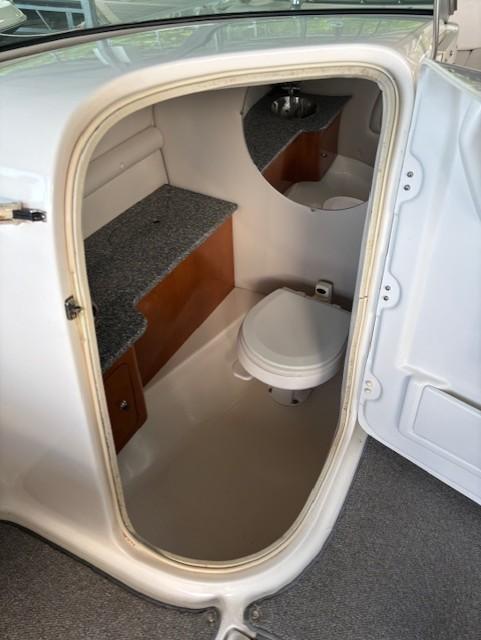 2007 Chaparral Sunesta 274 boat interior with compact bathroom and toilet.