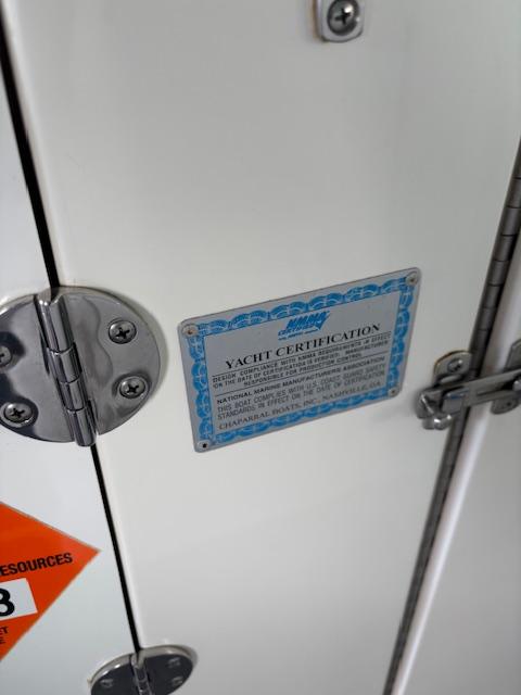 2007 Chaparral Sunesta 274 yacht certification plaque on a white surface with metal hinges.