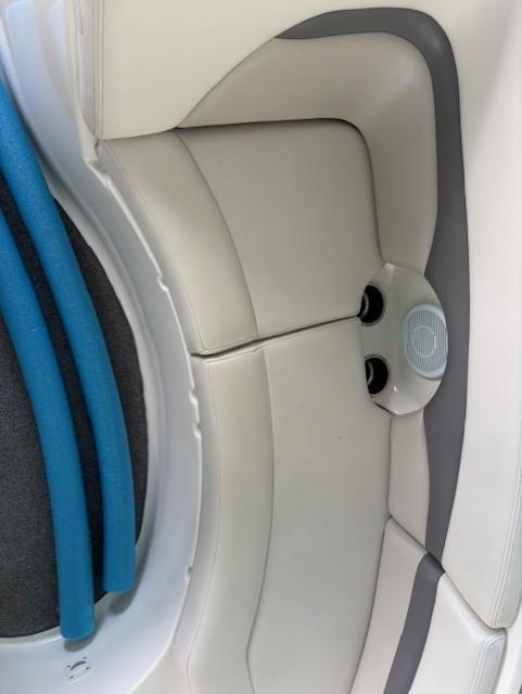 2007 Chaparral Sunesta 274 boat interior with white and gray seating, blue pool noodles.