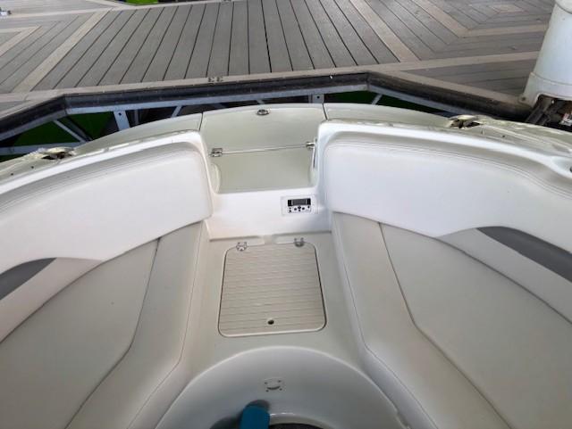 2007 Chaparral Sunesta 274 boat interior with white seating and storage compartments.