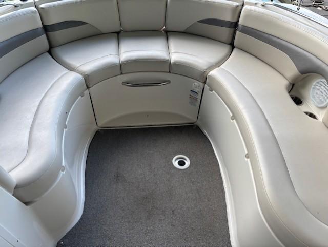 2007 Chaparral Sunesta 274 boat interior with curved seating and gray upholstery.