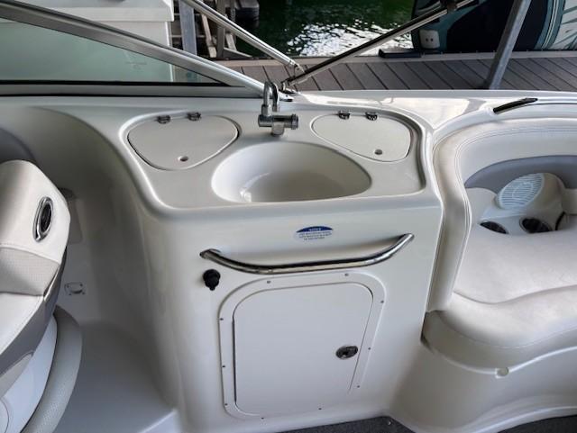 2007 Chaparral Sunesta 274 boat interior with sink and seating area.