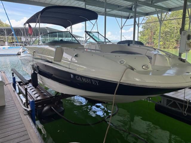 2007 Chaparral Sunesta 274 boat docked under a covered marina.