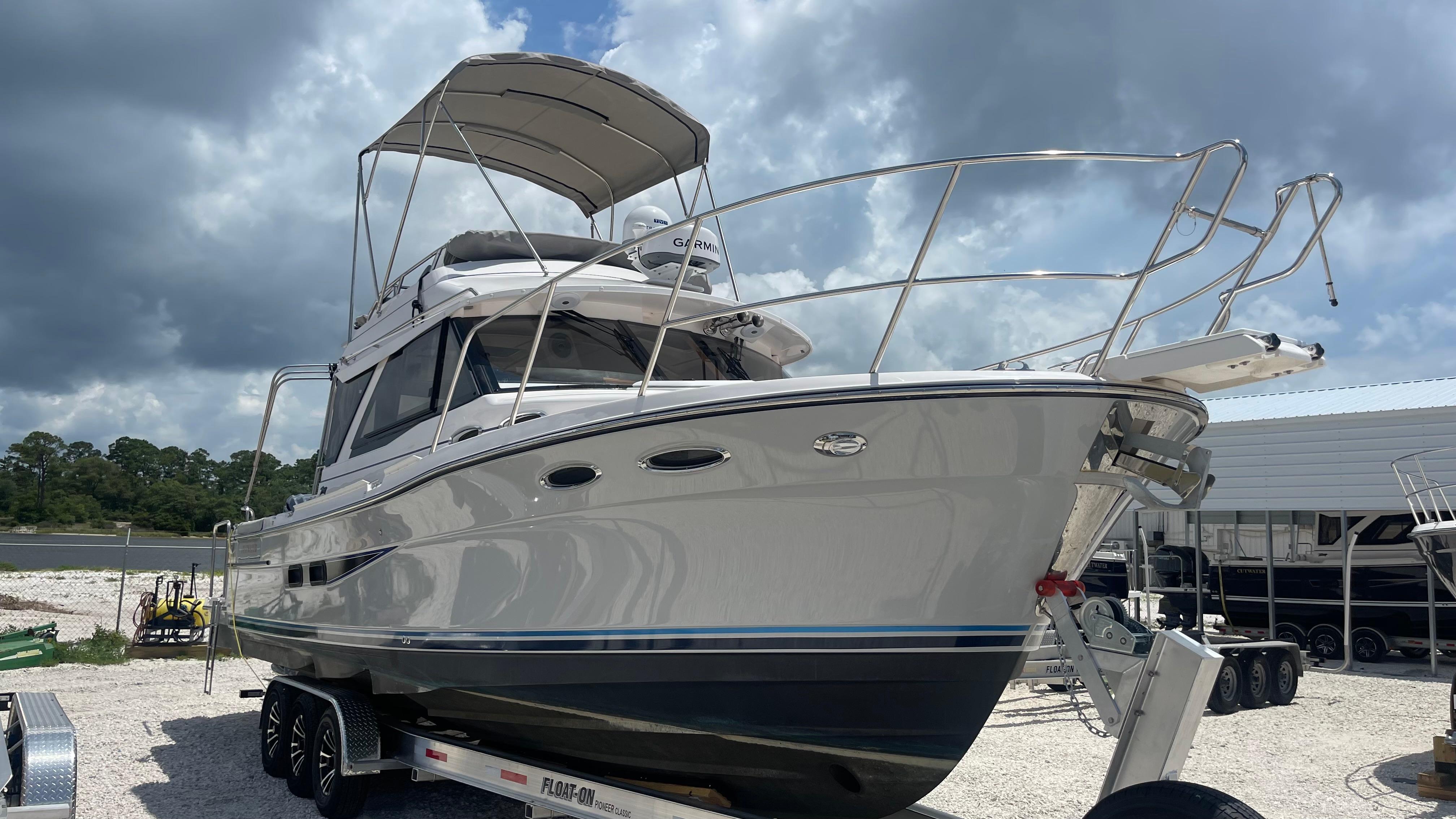 Picture of C32 CB 2025 Cutwater 37.67 ft' C-32 CB 2025 Cutwater C-32 CB boat on trailer under cloudy sky. 