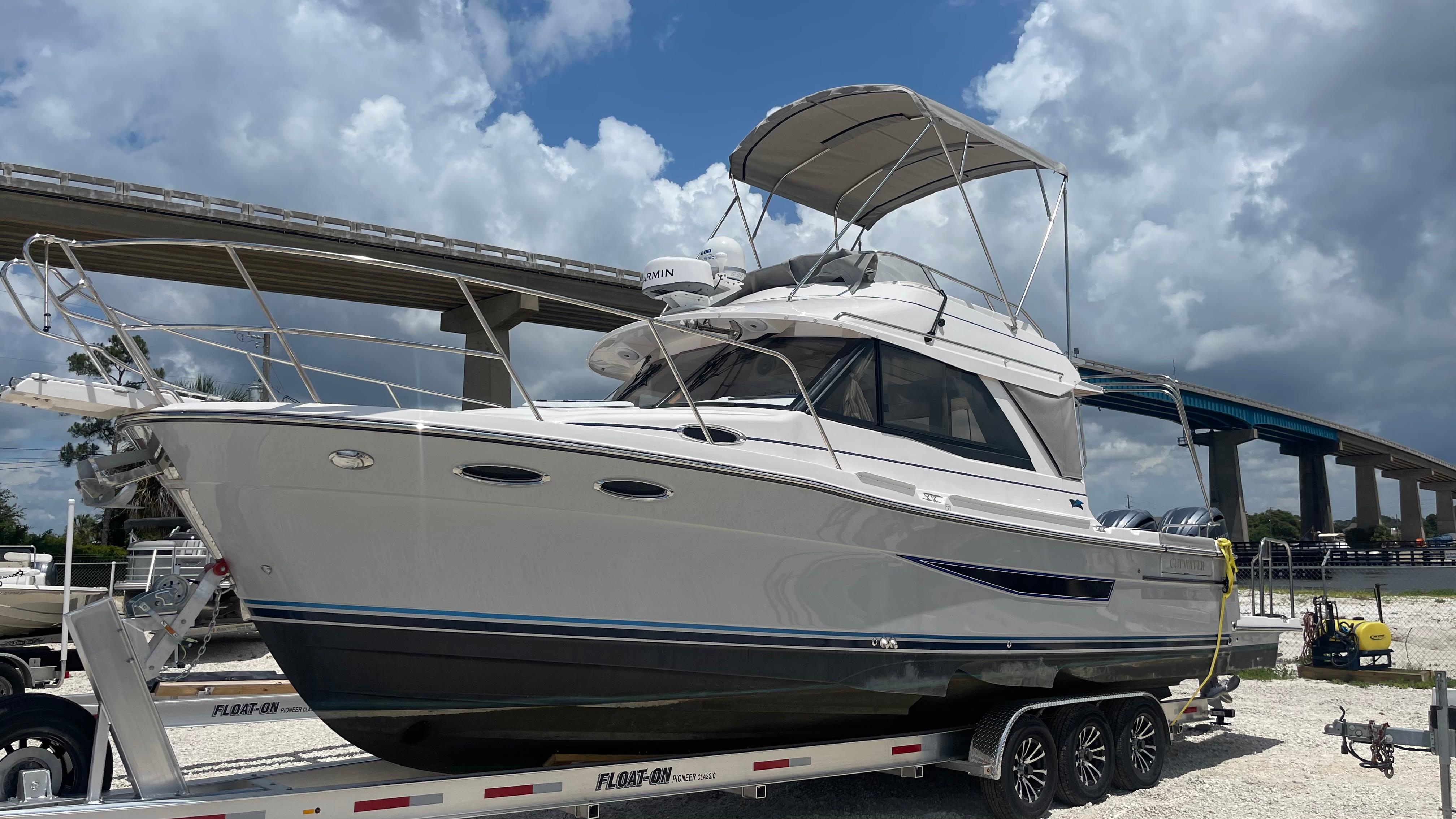 Picture of C32 CB 2025 Cutwater 37.67 ft' C-32 CB 2025 Cutwater C-32 CB boat on trailer under cloudy sky. 