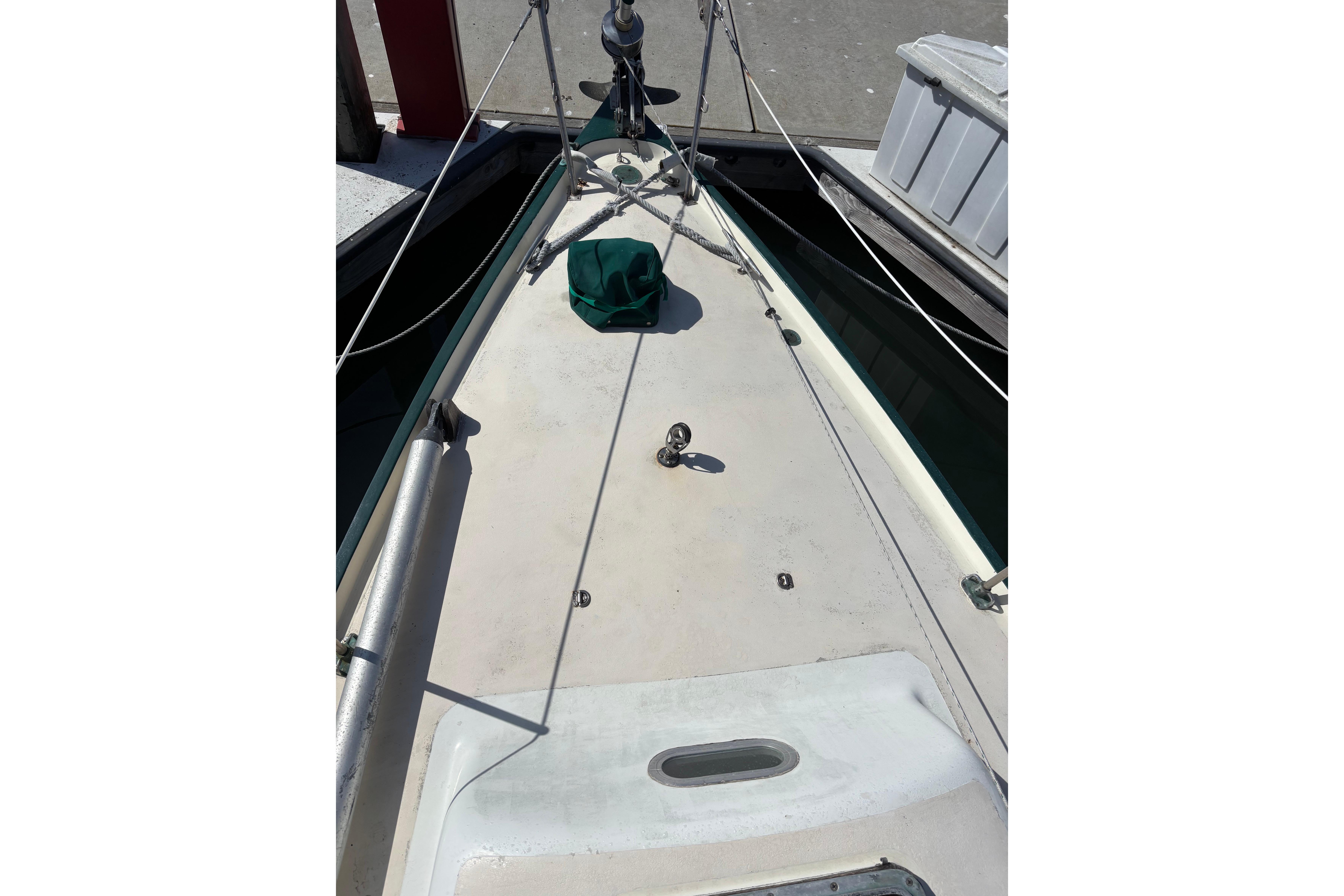 1968 Spencer 35 sailboat deck with rigging and dockside view.