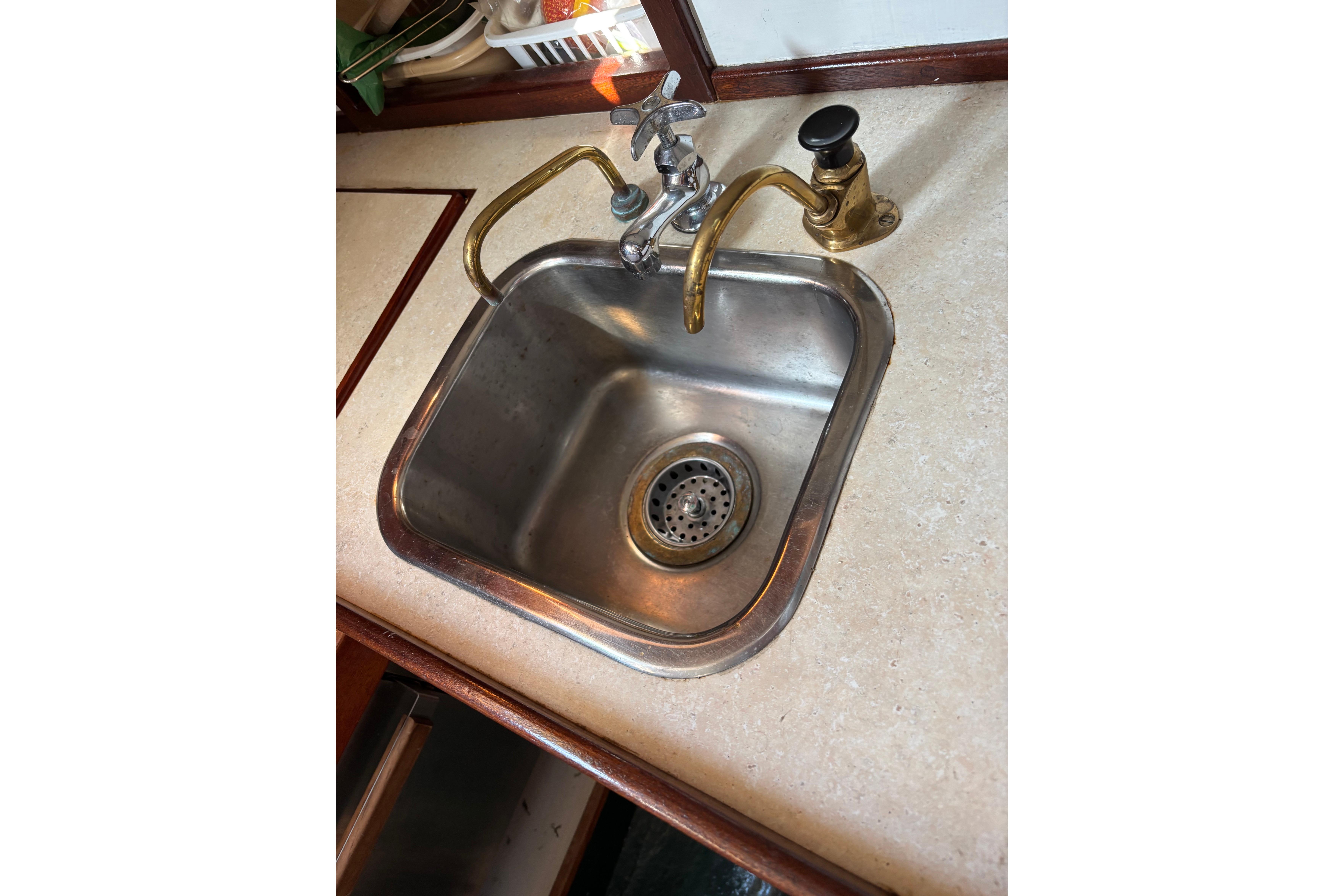 Stainless steel sink with brass faucet on Spencer 35, 1968 model boat.