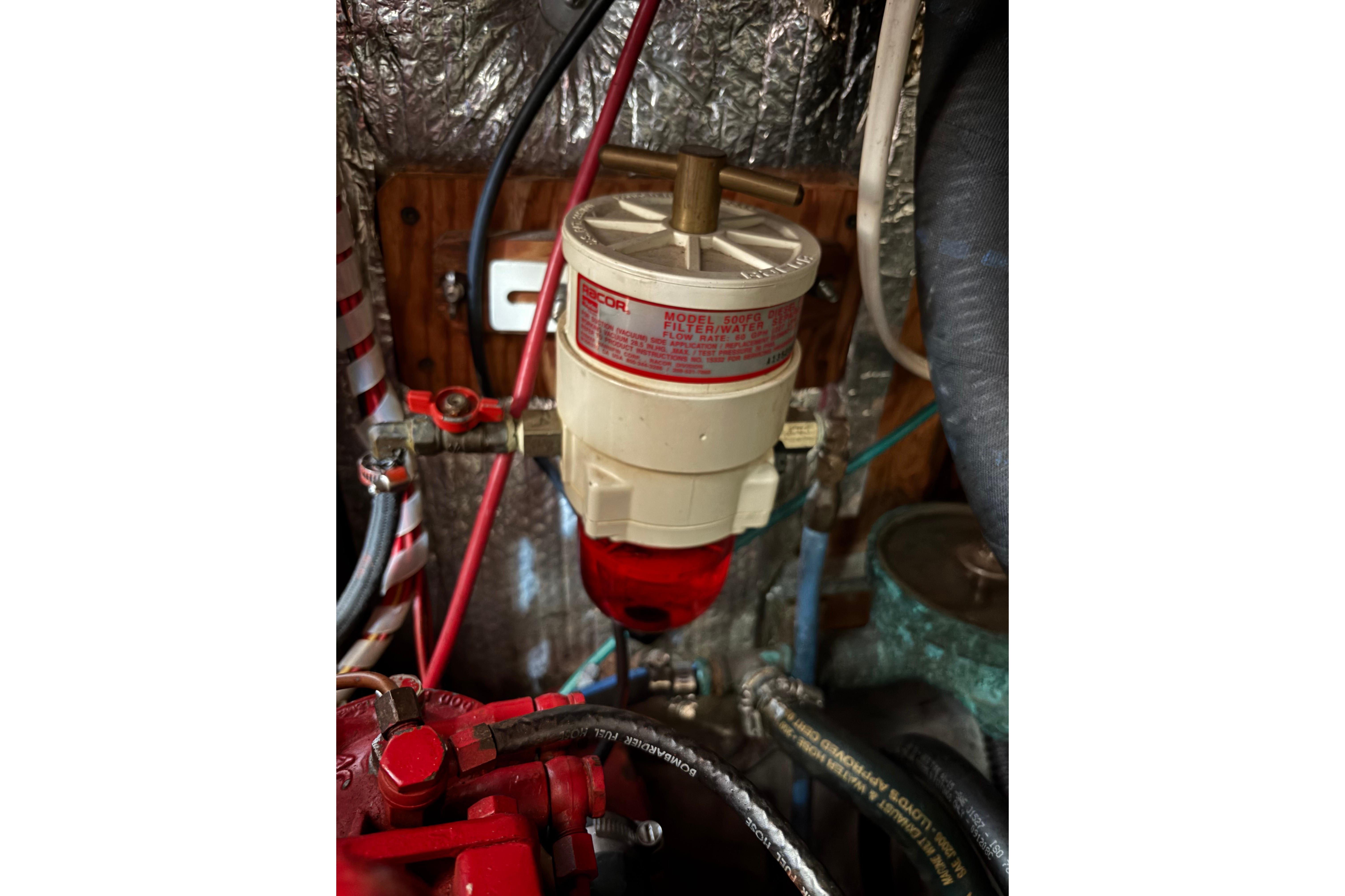 Engine compartment of a 1968 Spencer 35 with fuel filter system.