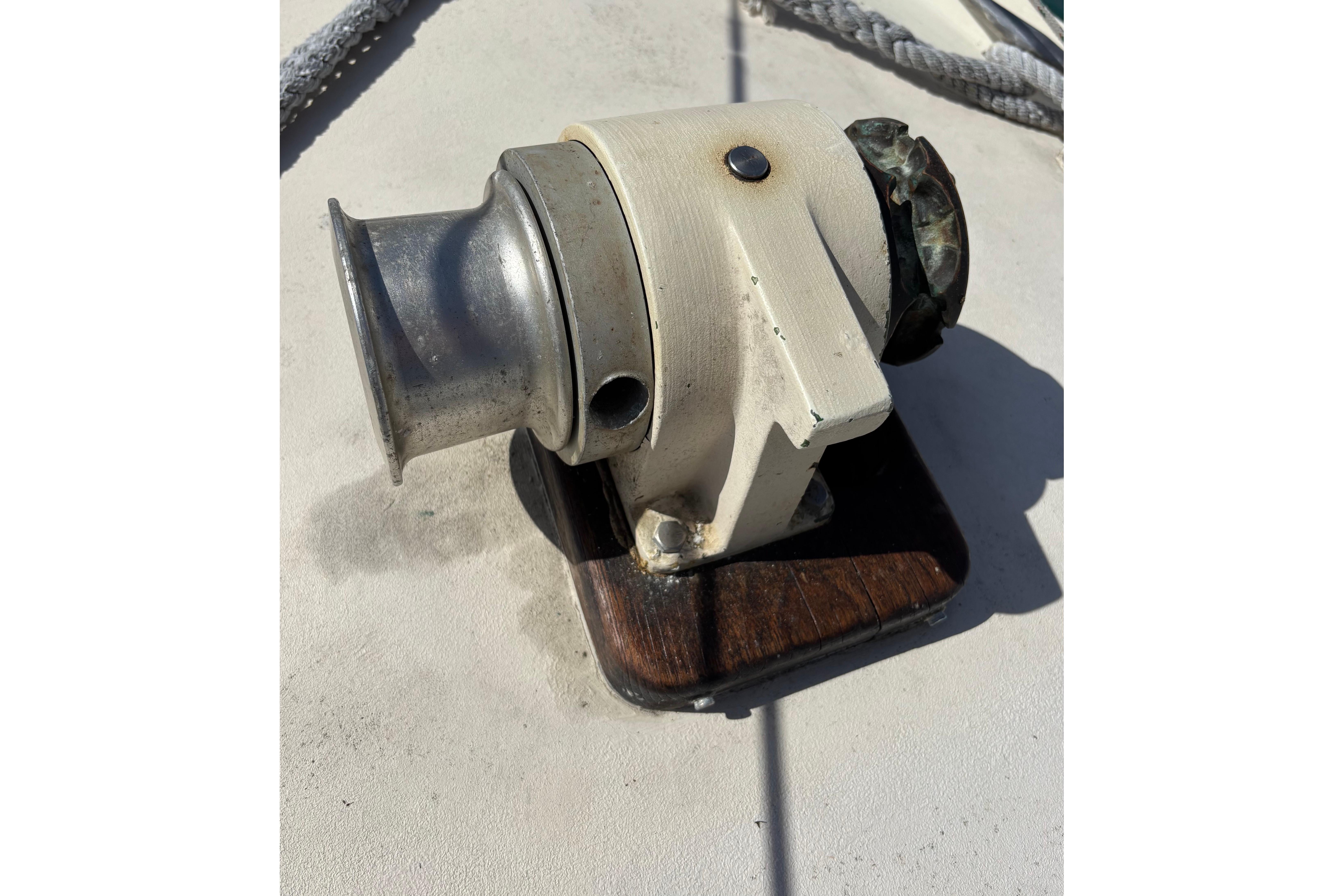 Vintage 1968 Spencer 35 boat winch on deck, featuring metal and wood components.