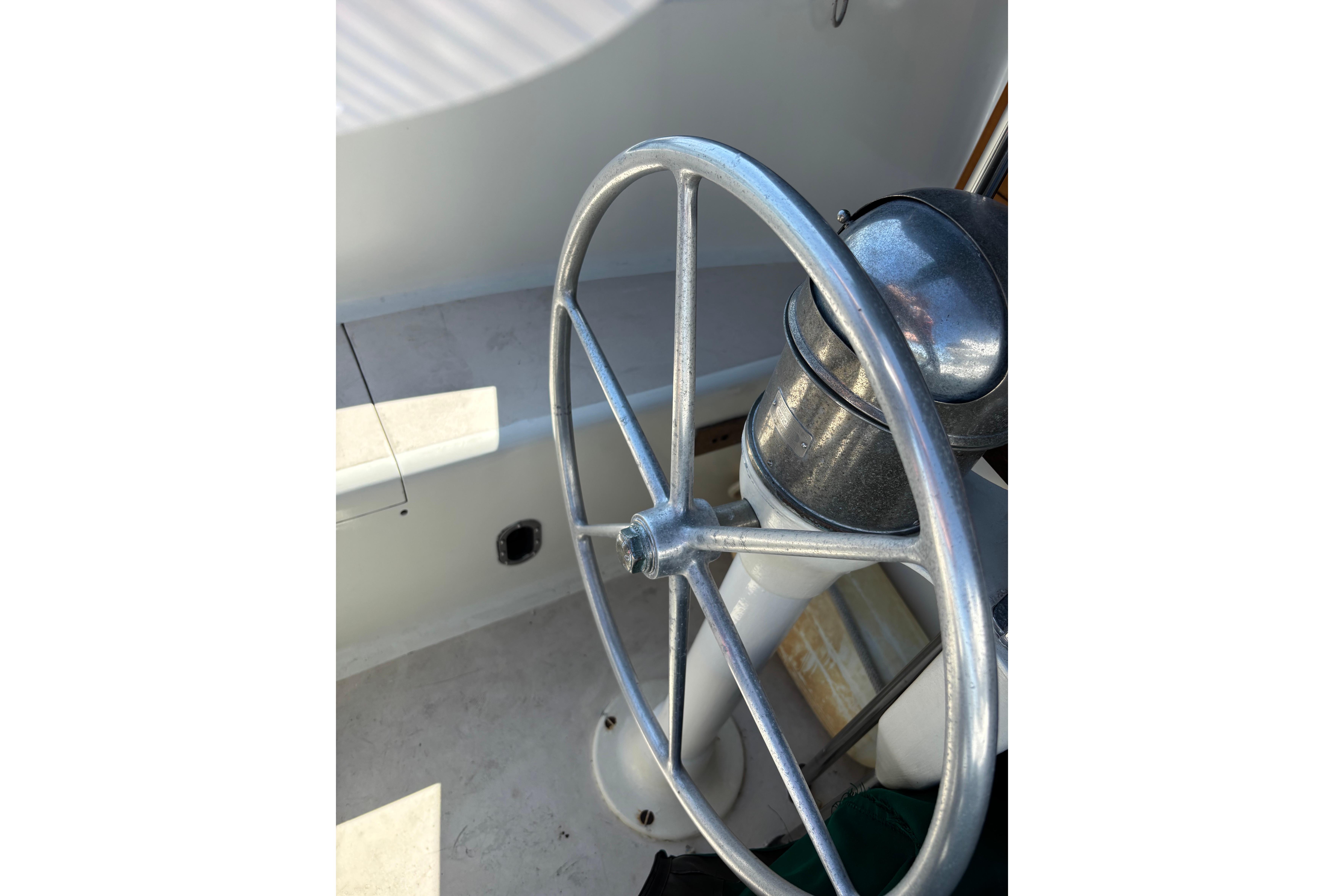 Steering wheel of a 1968 Spencer 35 boat, showcasing vintage nautical design.
