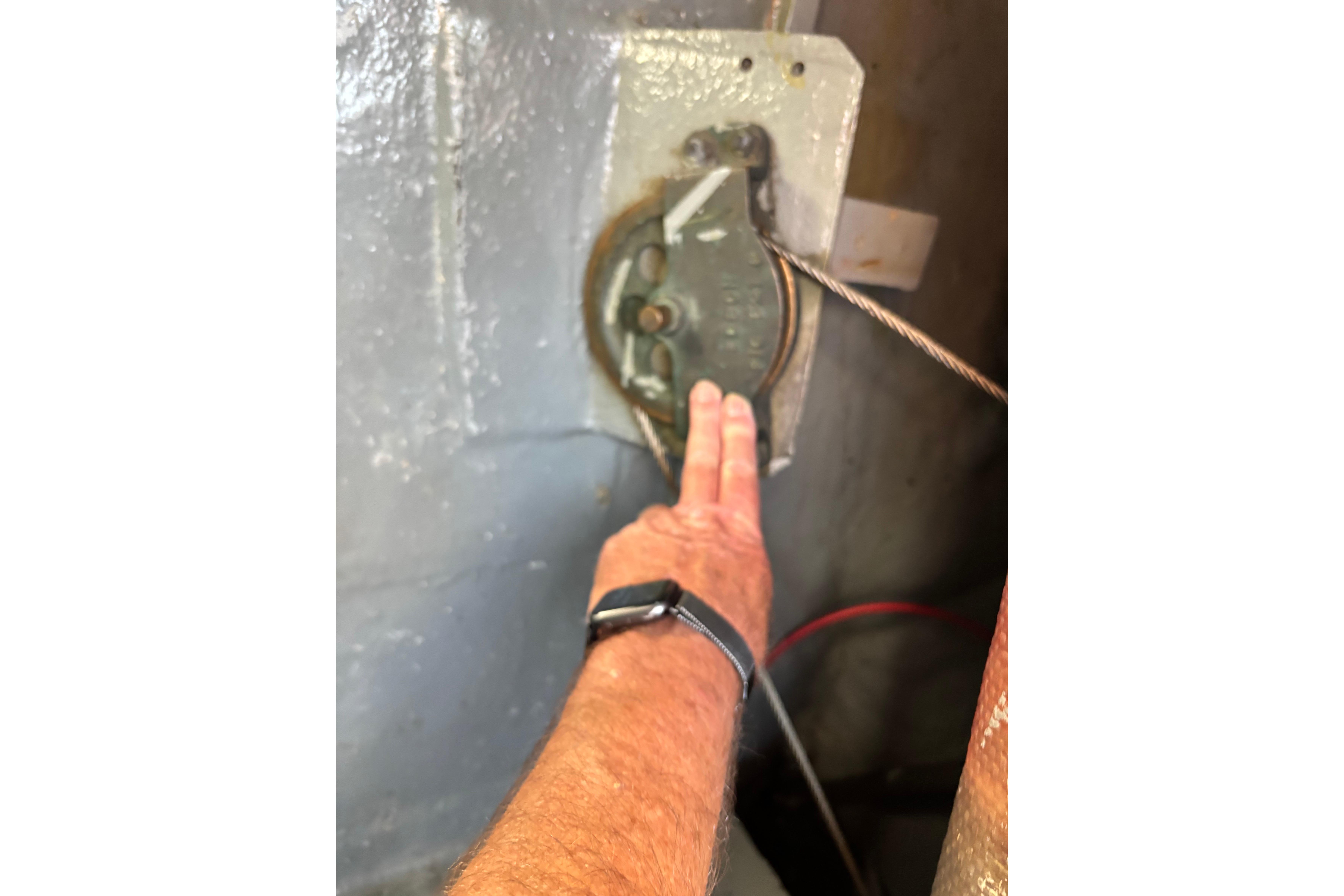 Hand adjusting mechanism on Spencer 35, 1968 model, with visible cable and watch.