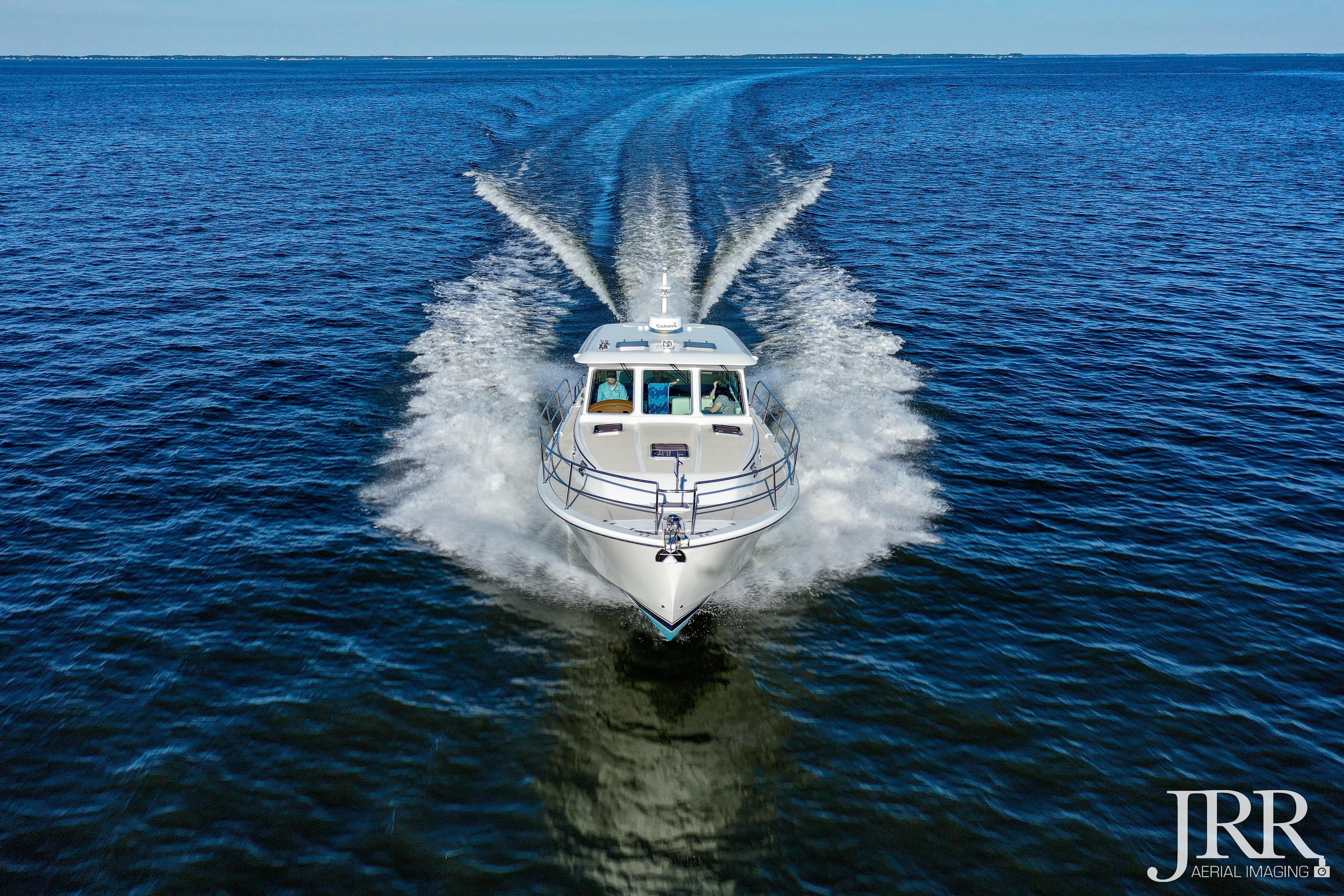 2019 Sabre 38 Salon Express cruising on open water, aerial view.