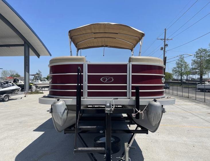 2018 Veranda 22 pontoon boat with canopy on trailer, parked outdoors.