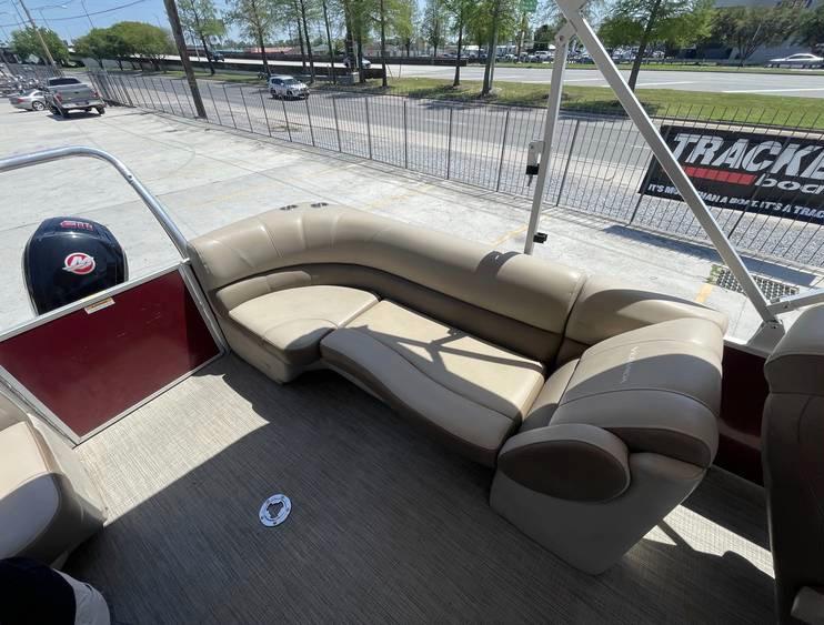 2018 Veranda 22 pontoon boat with beige seating and outdoor view.