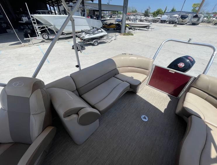2018 Veranda 22 pontoon boat interior with beige seating and outdoor storage area.
