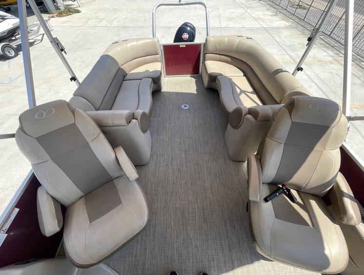 2018 Veranda 22 pontoon boat interior with beige seating and spacious layout.