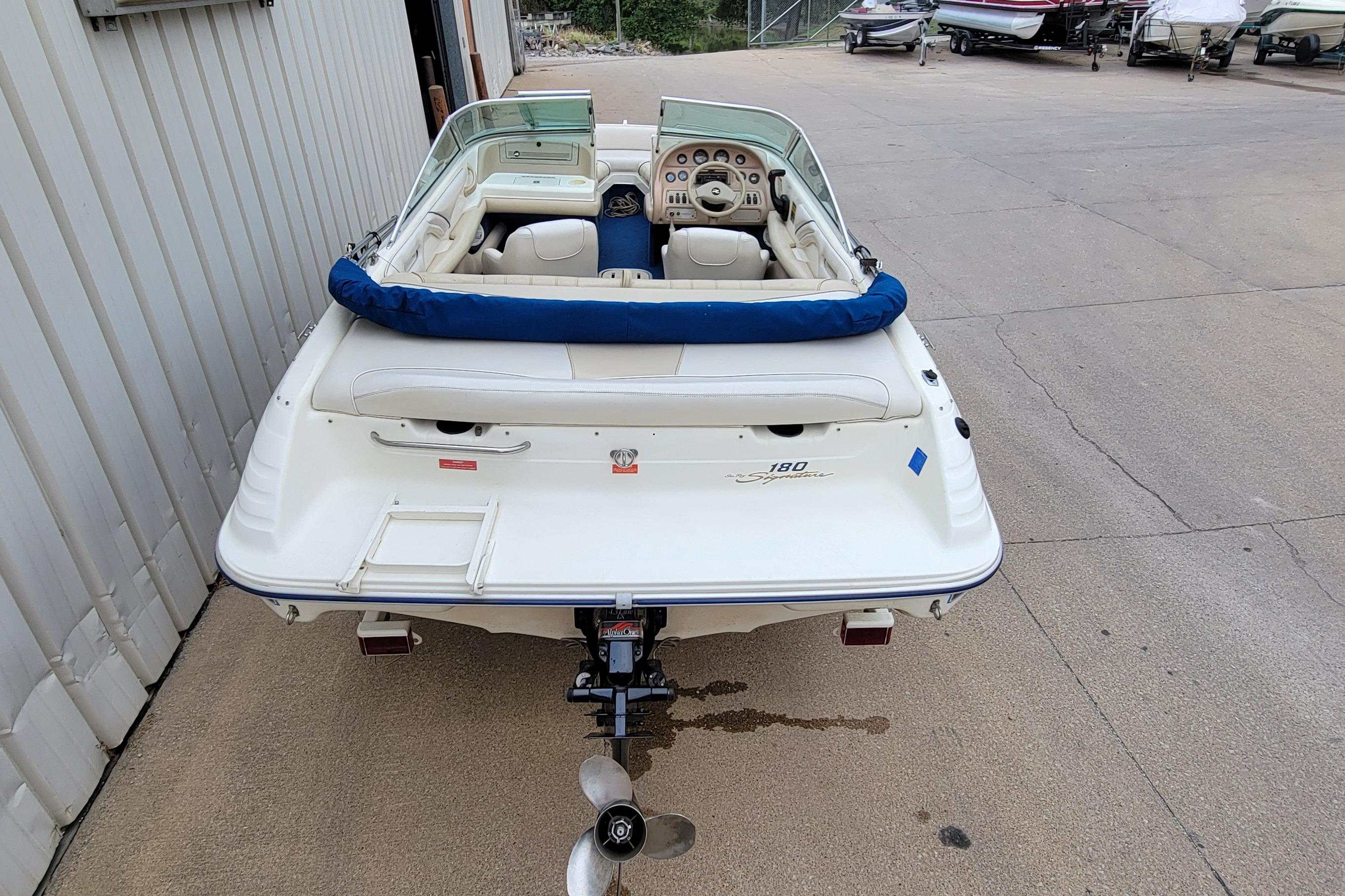 1994 Sea Ray 180 Bow Rider boat, rear view, parked on concrete surface.