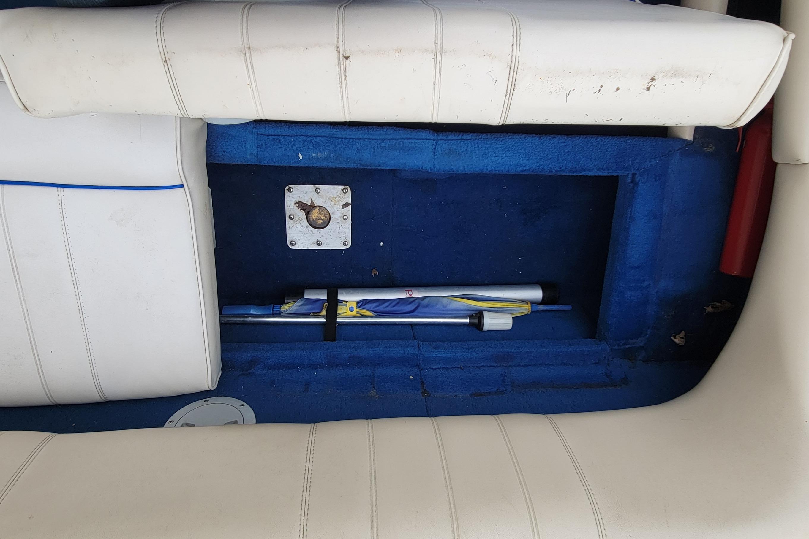 1994 Sea Ray 180 Bow Rider interior with blue carpet and white seating.