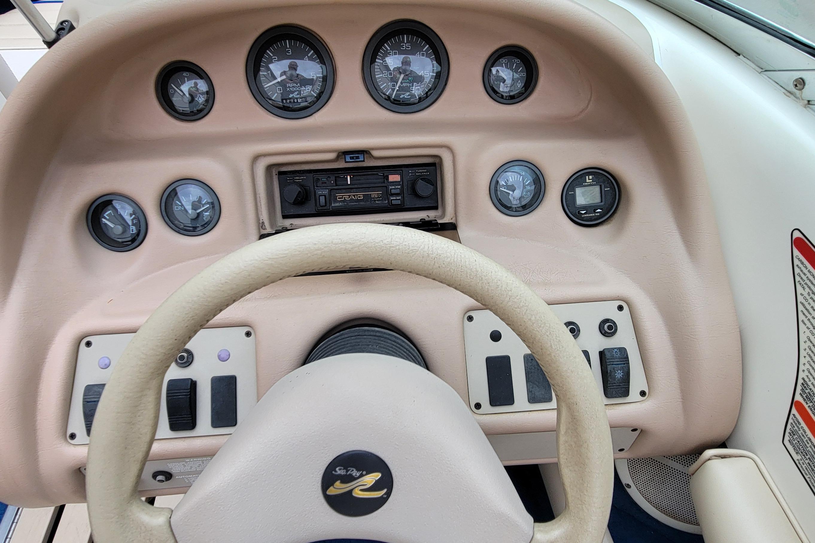 1994 Sea Ray 180 Bow Rider dashboard with gauges and steering wheel.