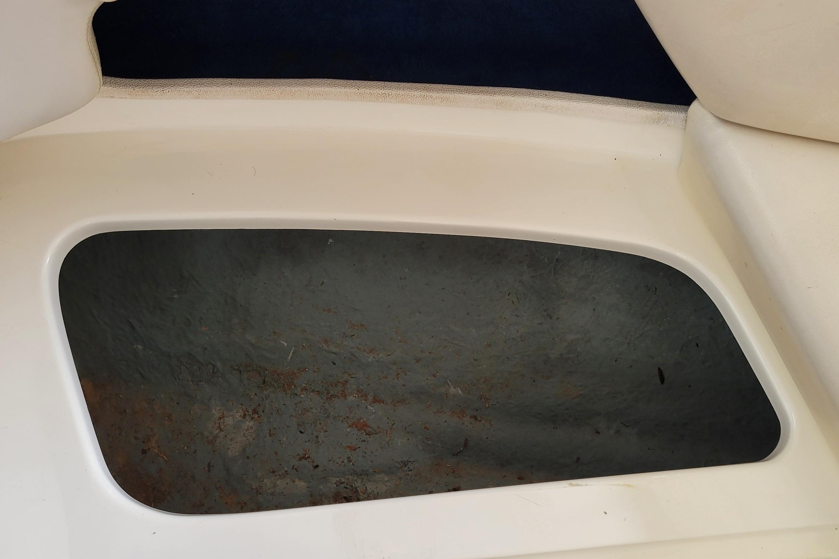 Storage compartment of a 1994 Sea Ray 180 Bow Rider boat.
