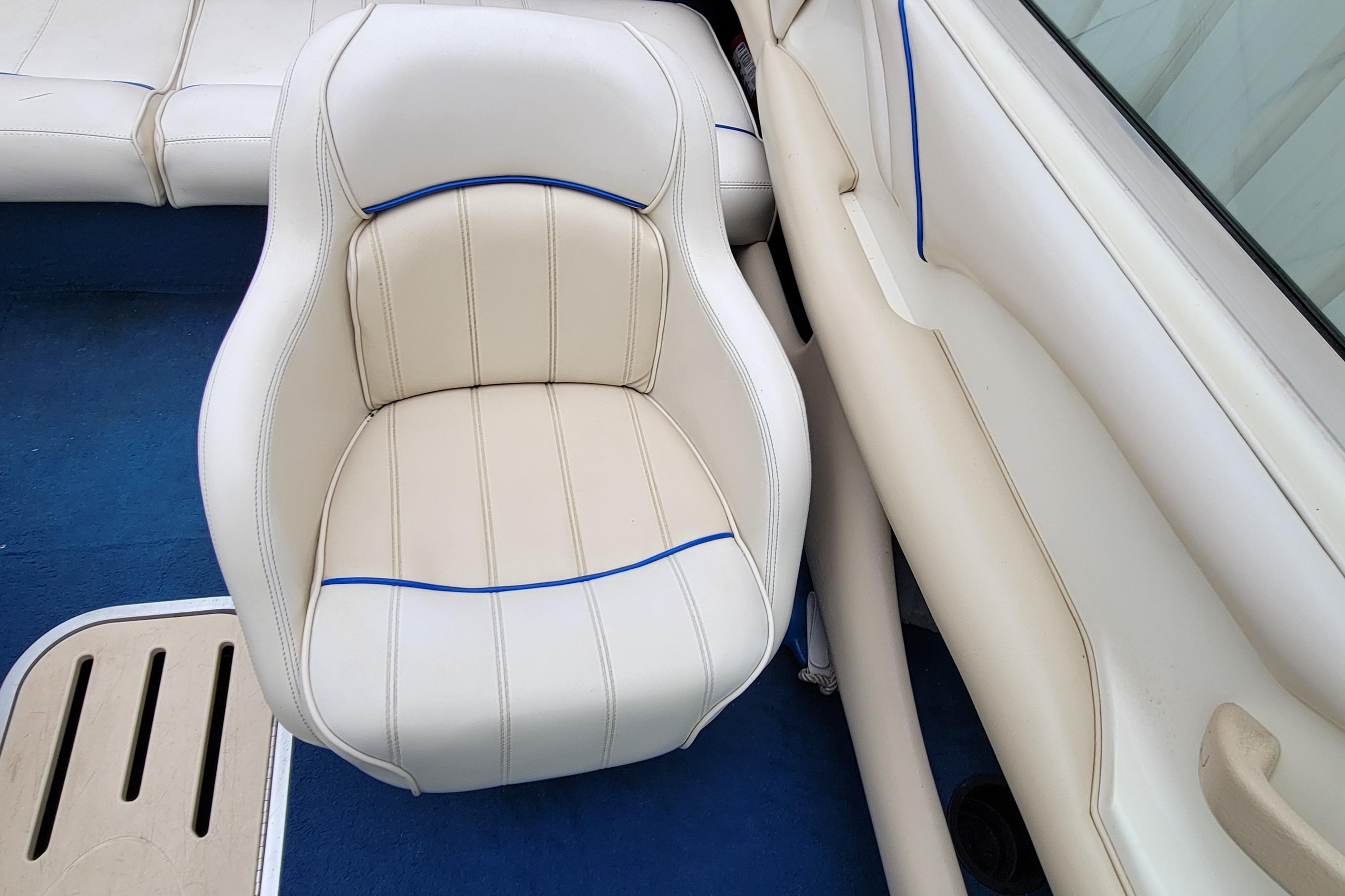 1994 Sea Ray 180 Bow Rider interior with white and blue-trimmed seating.
